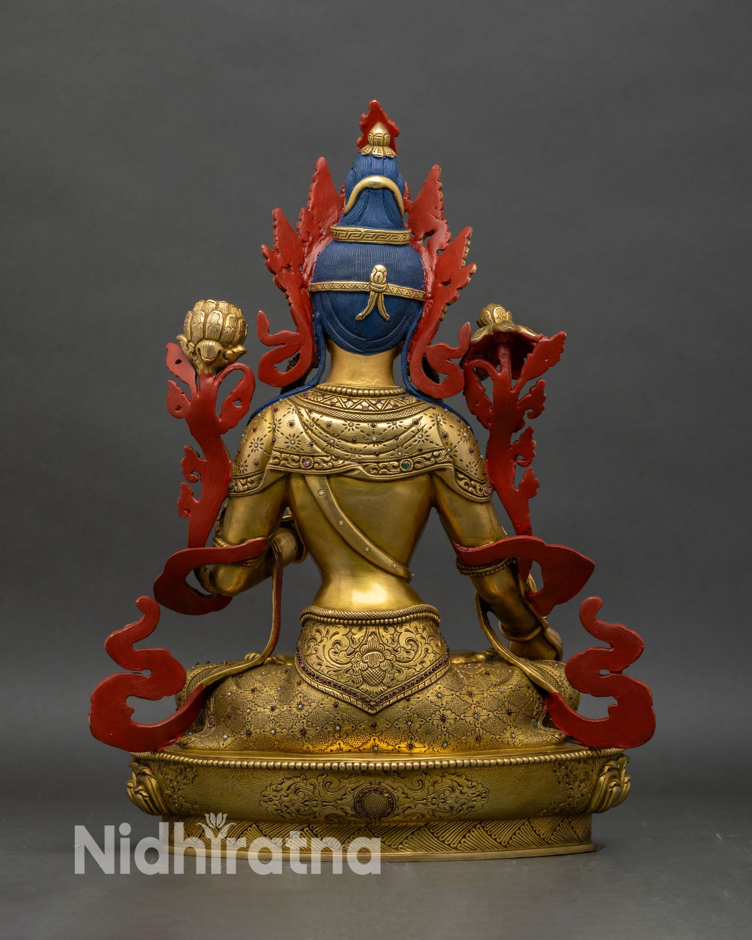 Back view of White Tara statue, detailed lotus pedestal and copper-gold craftsmanship