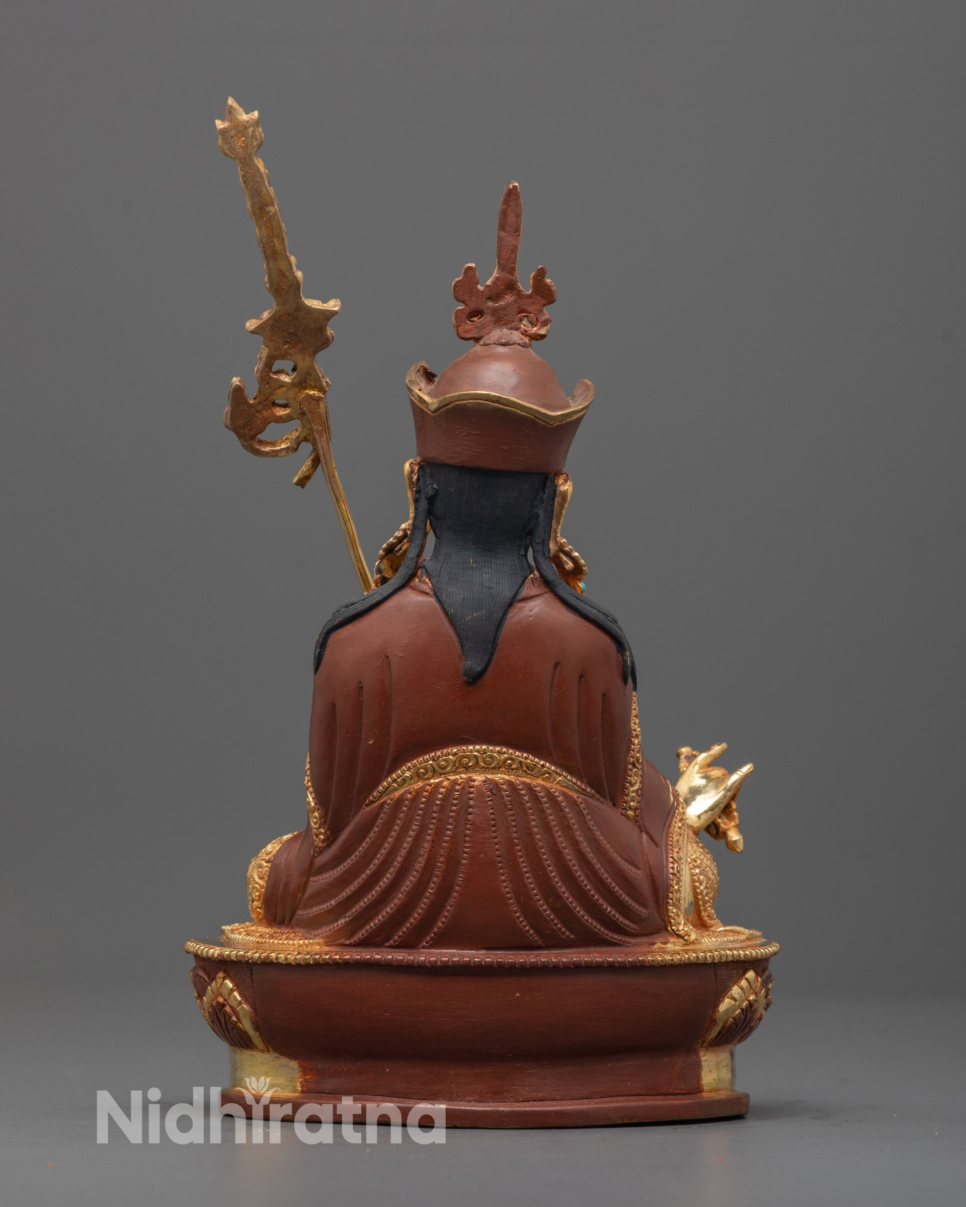 back angle Padmasambhava Statue with khatvanga staff and traditional Himalayan robe carvings