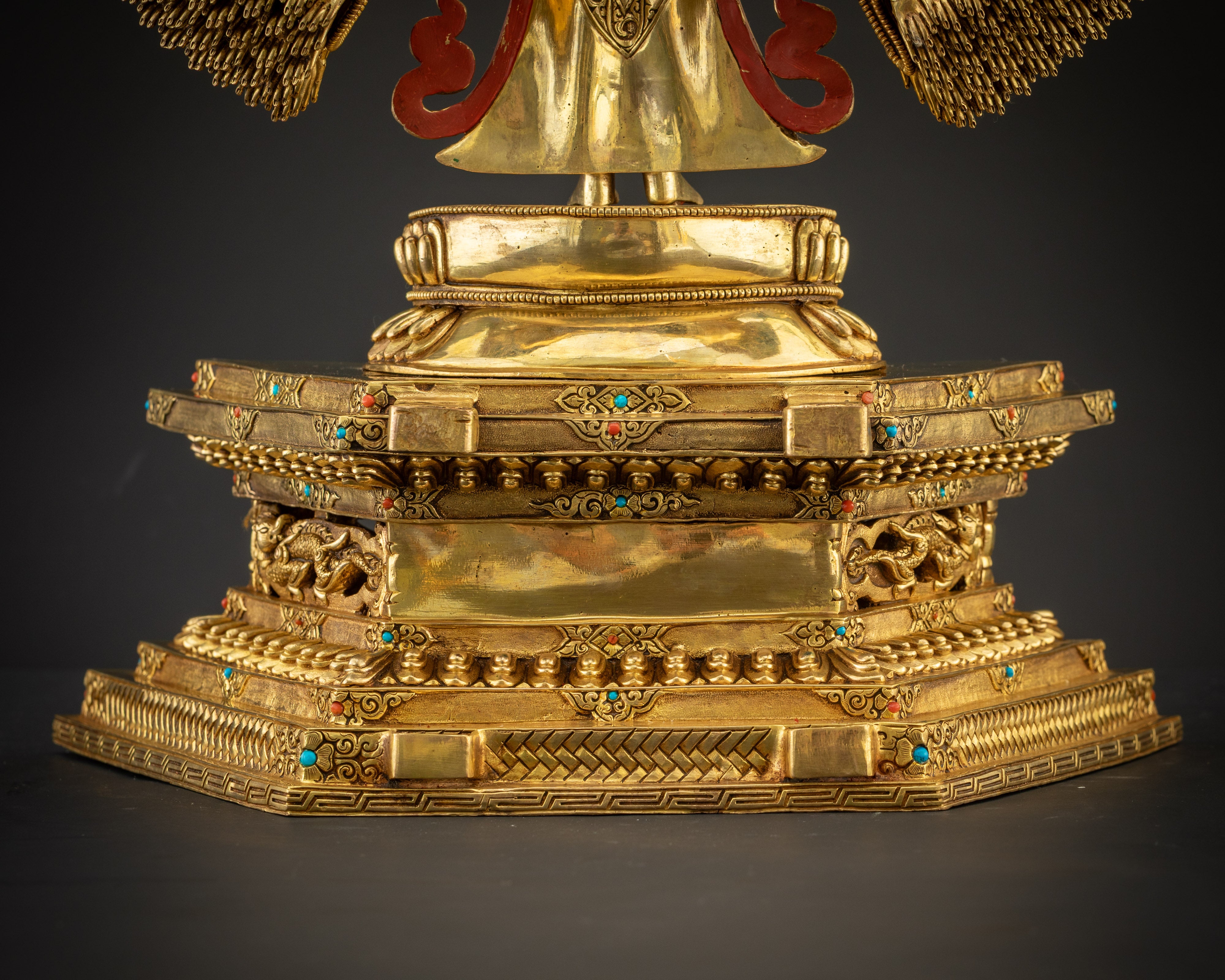 back carved detail Avalokiteshvara statue rear carving with red aureole and symbols Nepal