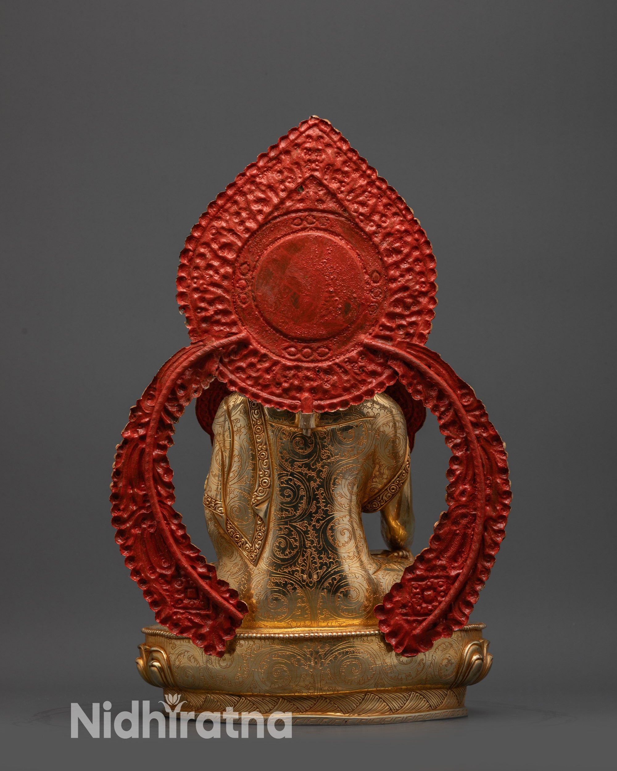 back view Jowo Shakyamuni Buddha statue showing engraved halo and finely detailed robe carvings