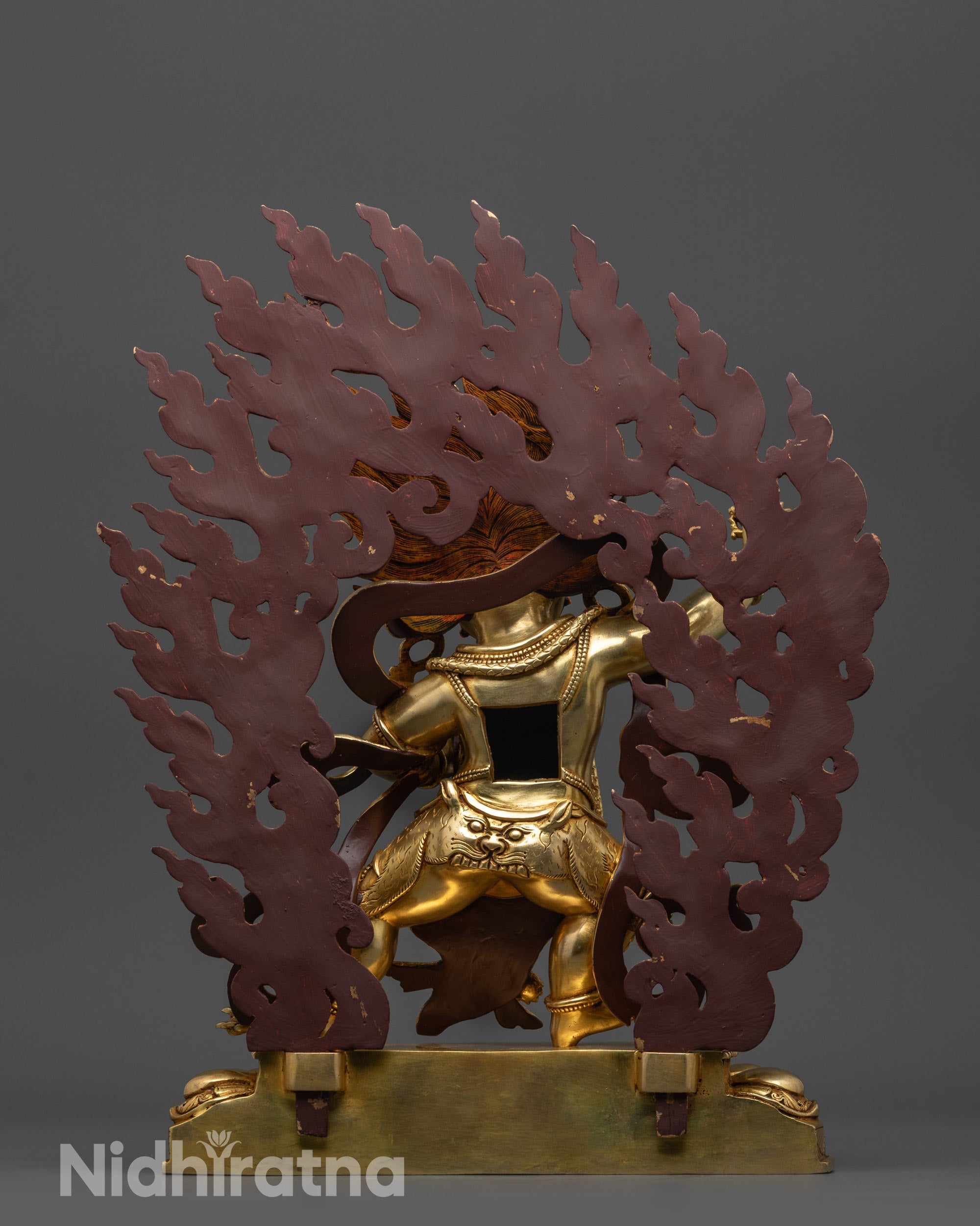 back view Vajrapani statue with flaming halo and flowing robes on copper base