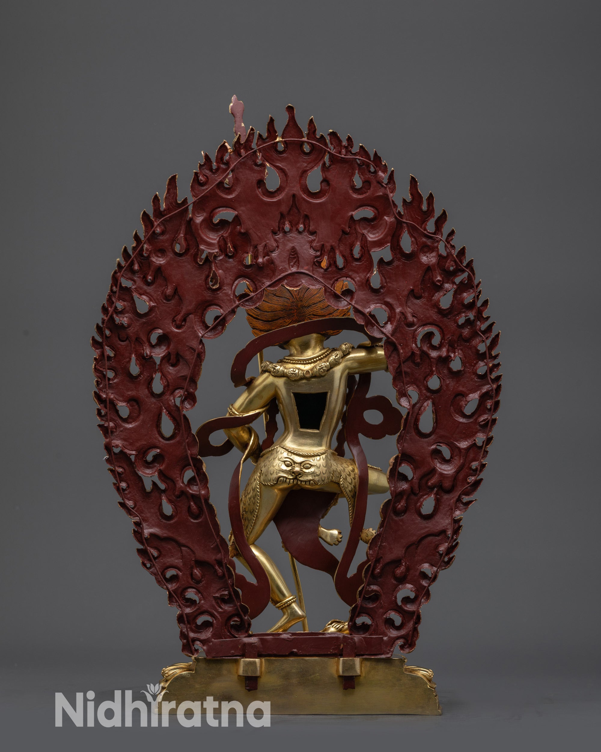back view gold-gilded Simha Mukha statue showing detailed halo and tiger-skin robe
