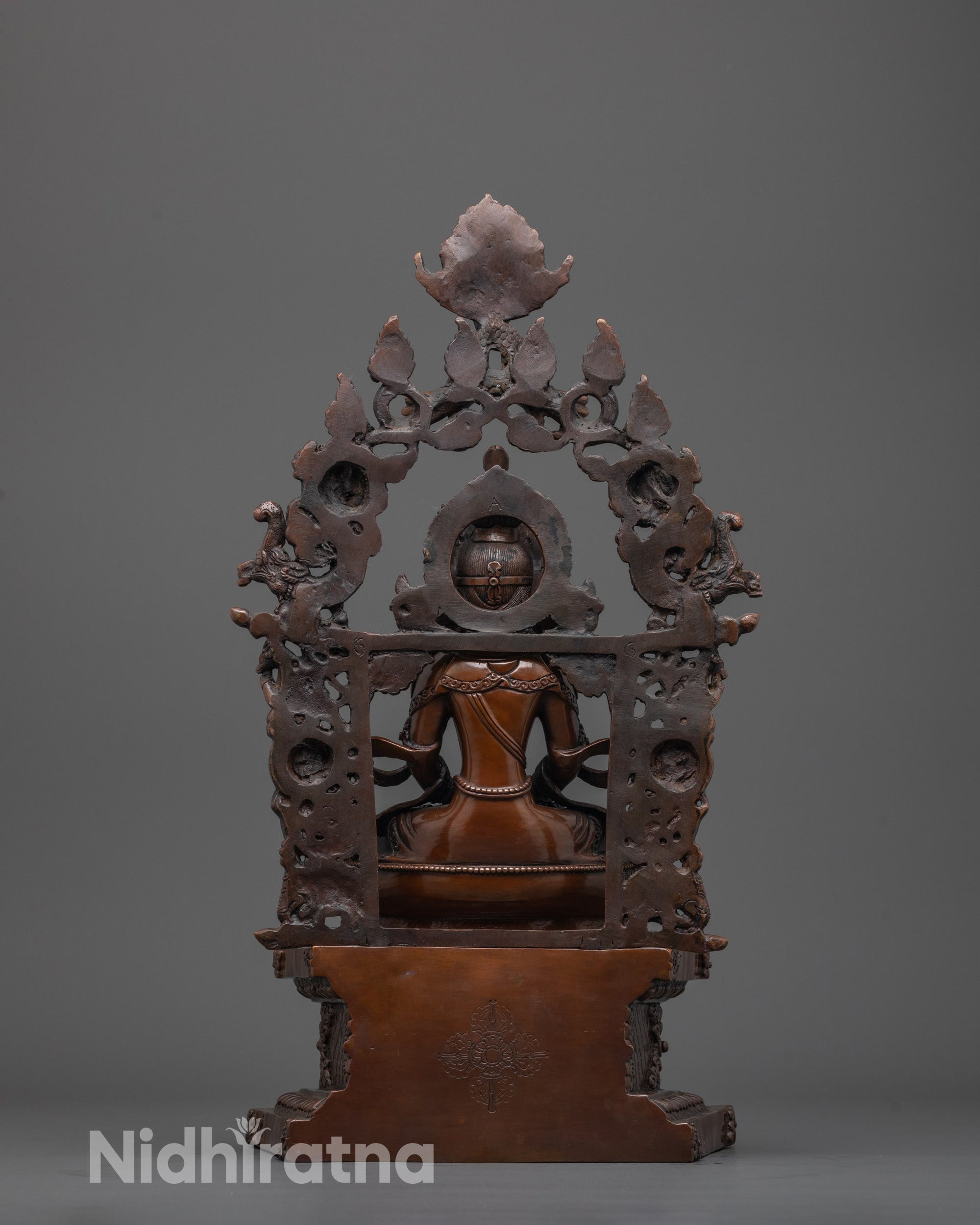 back view of Amitayus statue showing Vishva Vajra symbol and detailed oxidized finish