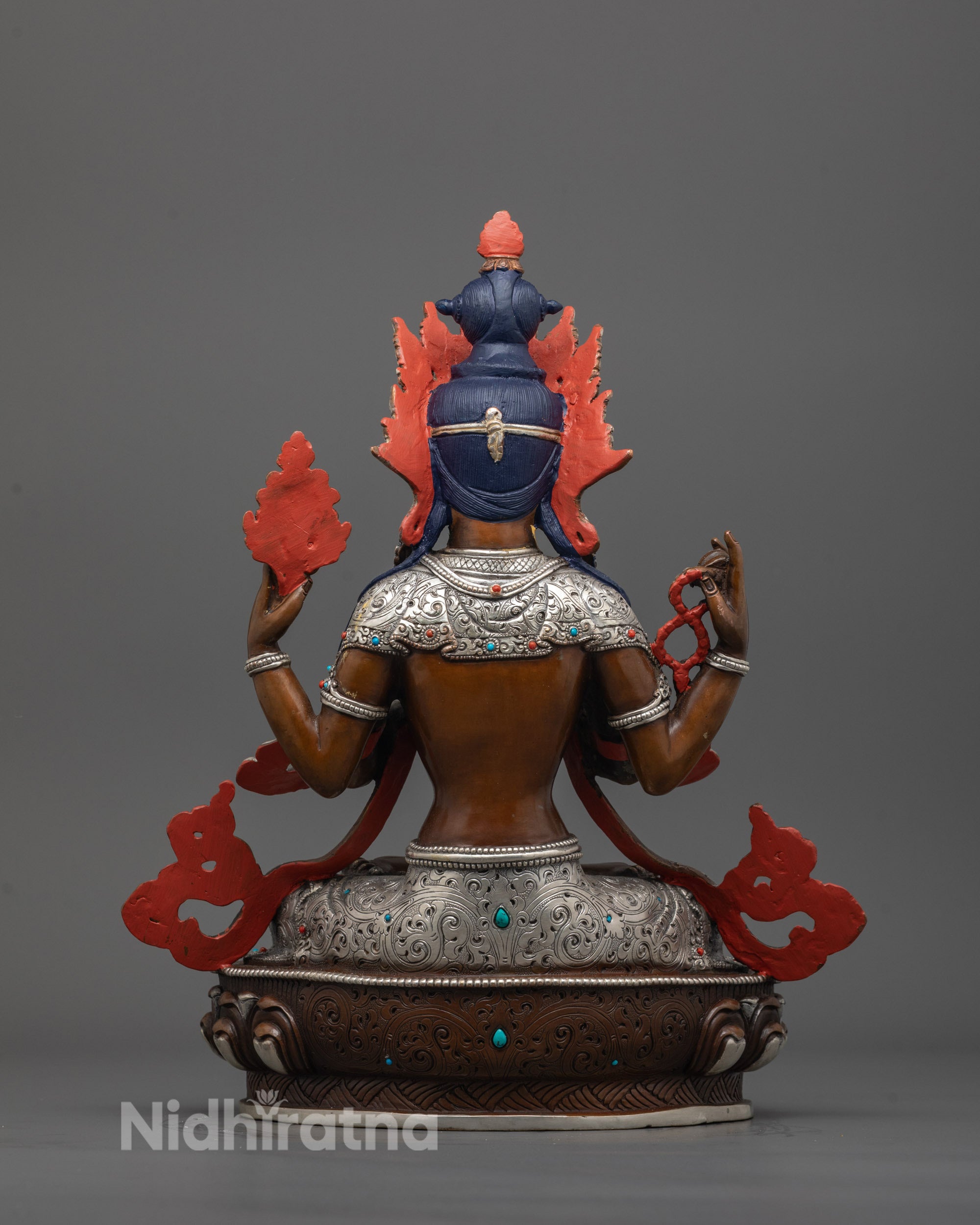 back view of Chenrezig Statue highlighting oxidized finish and silver-plated carvings
