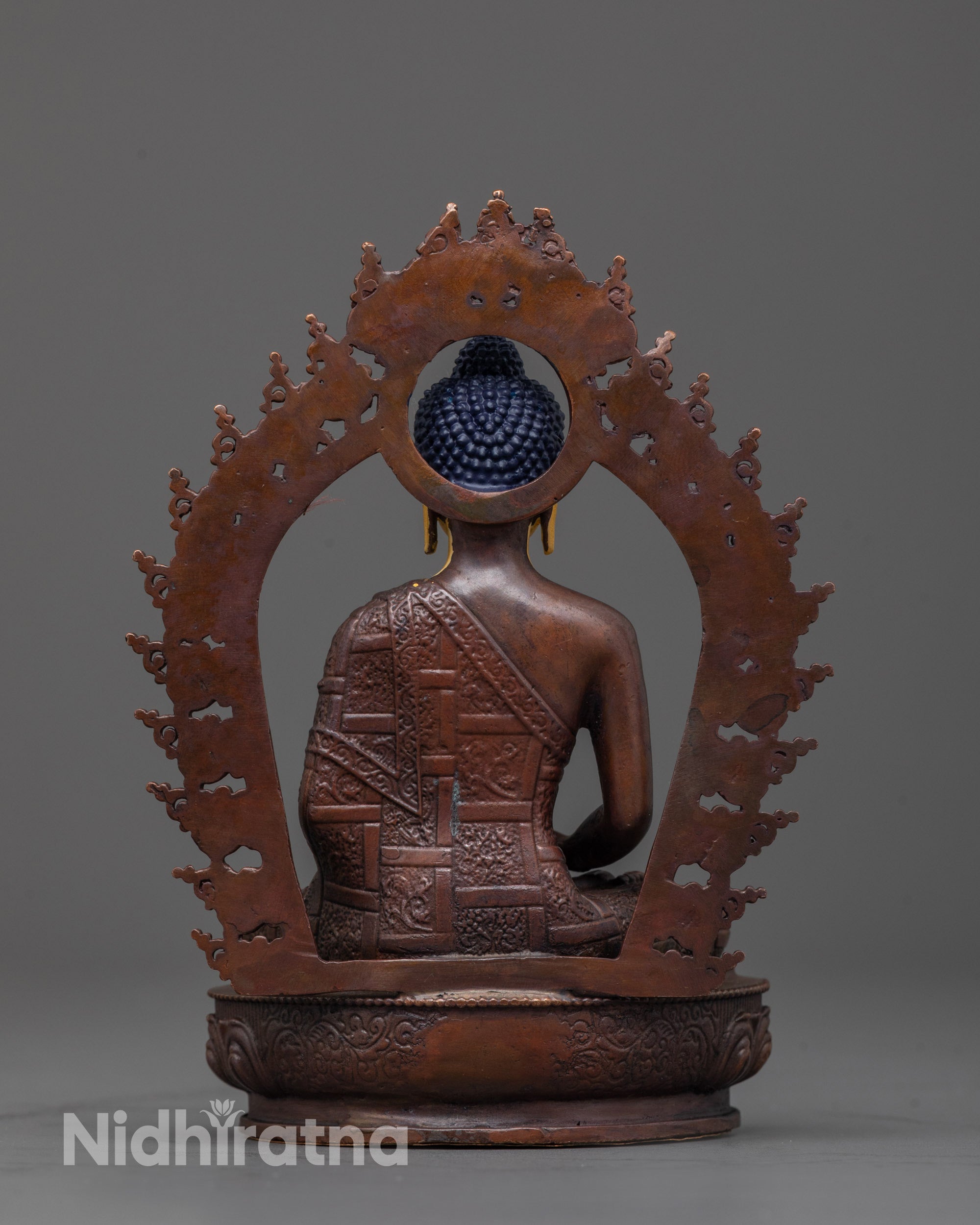 back view of amitabha statue with oxidized copper finish and radiant halo design