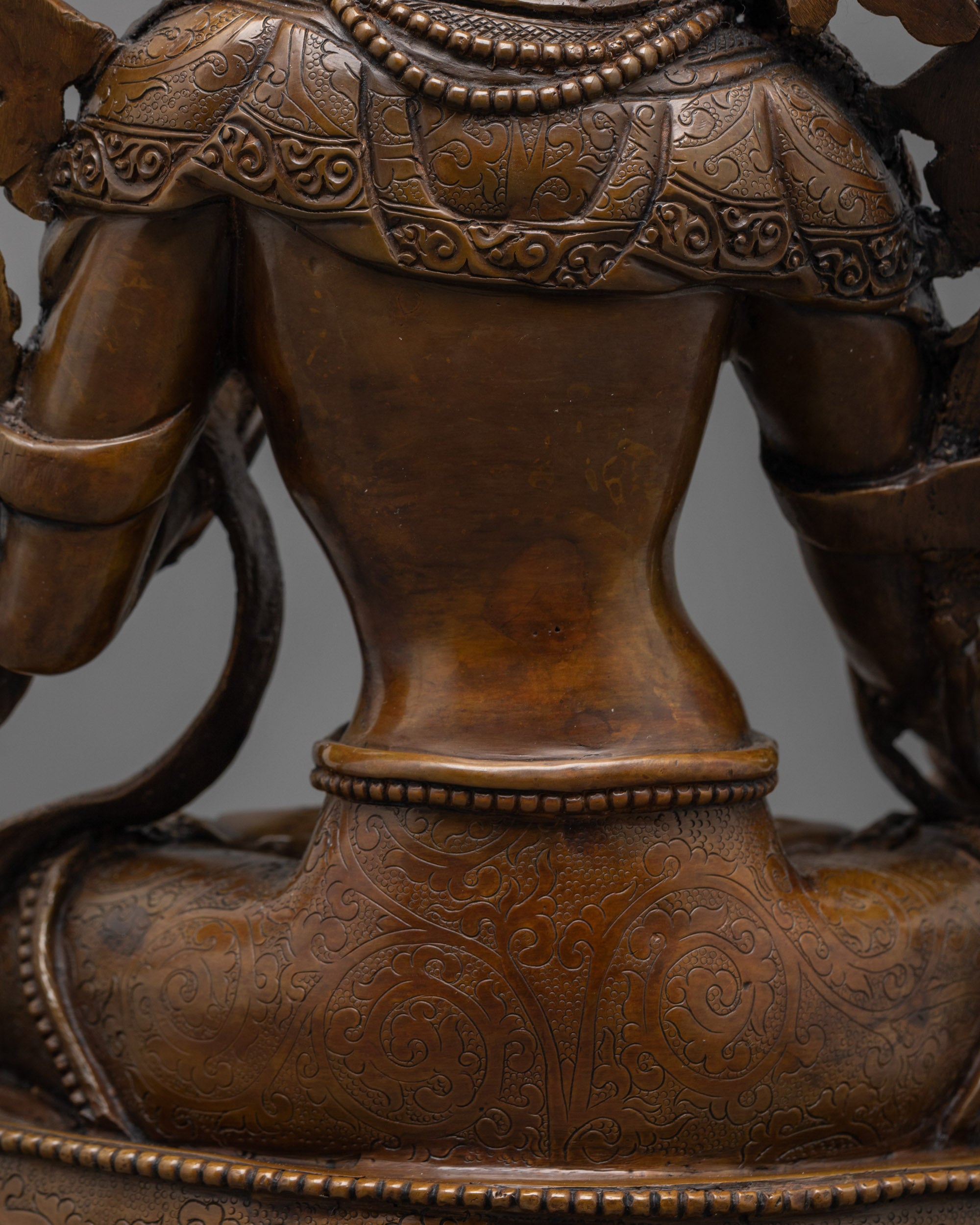 back view of handcrafted white tara statue with lotus seat and fine oxidized copper detailing
