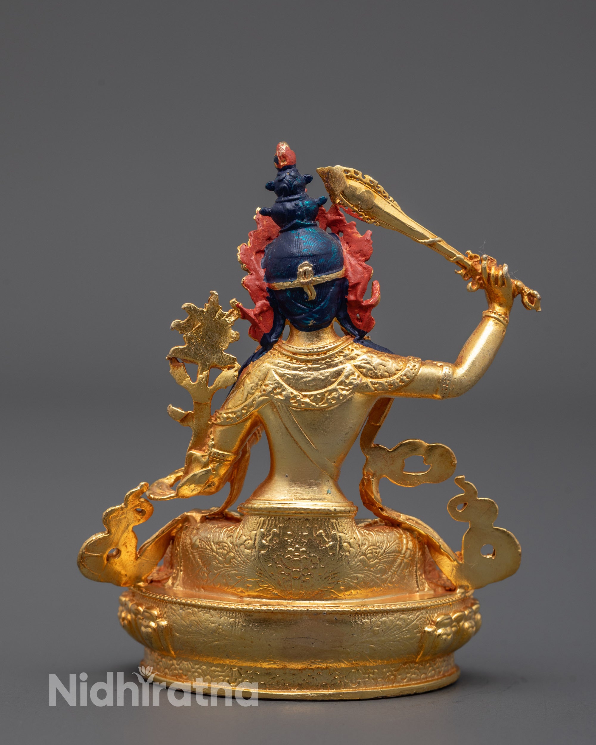 back view of manjushri sculpture showing detailed robes and smooth electroplated surface