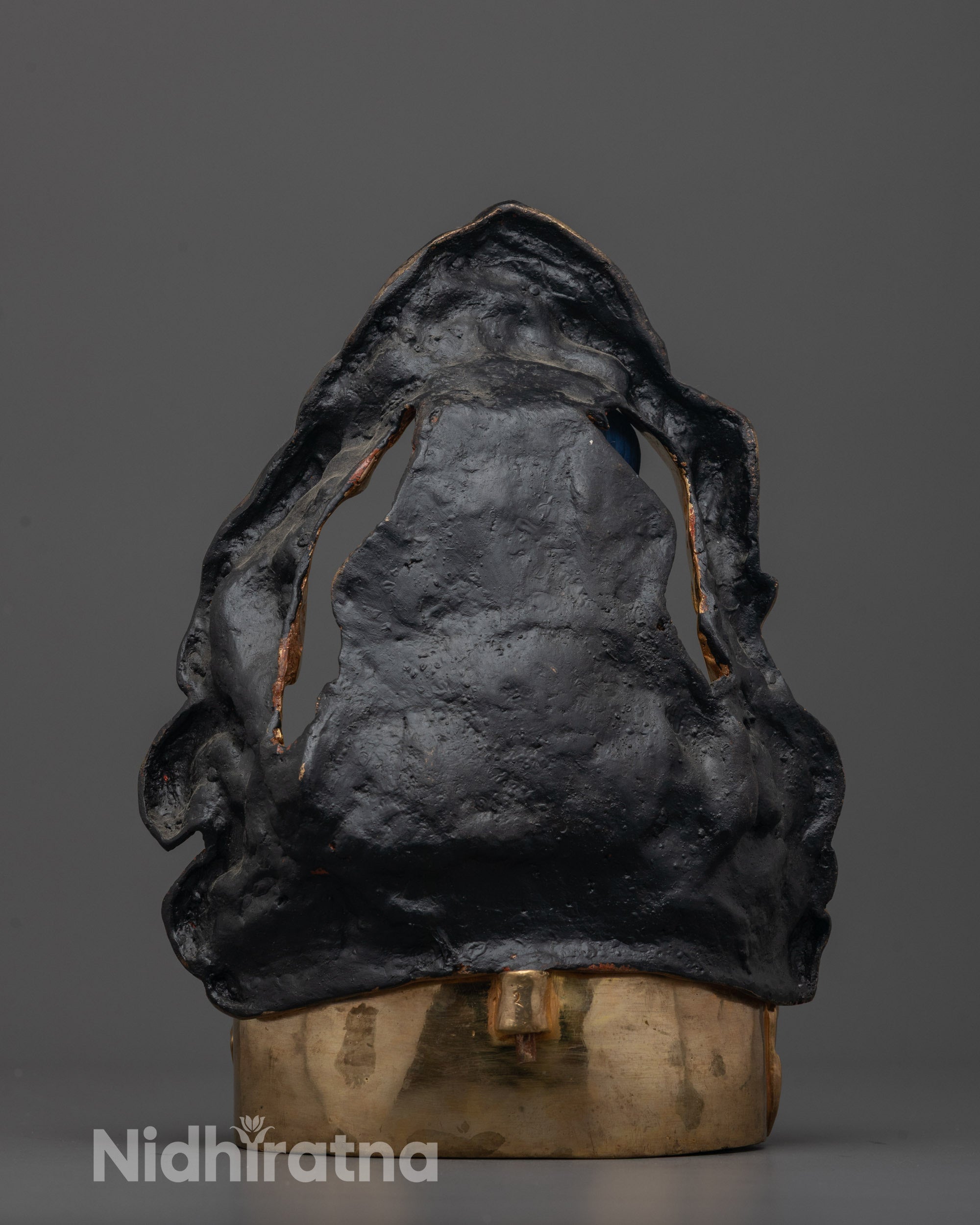 back view of milarepa buddhist statue with traditional copper craftsmanship