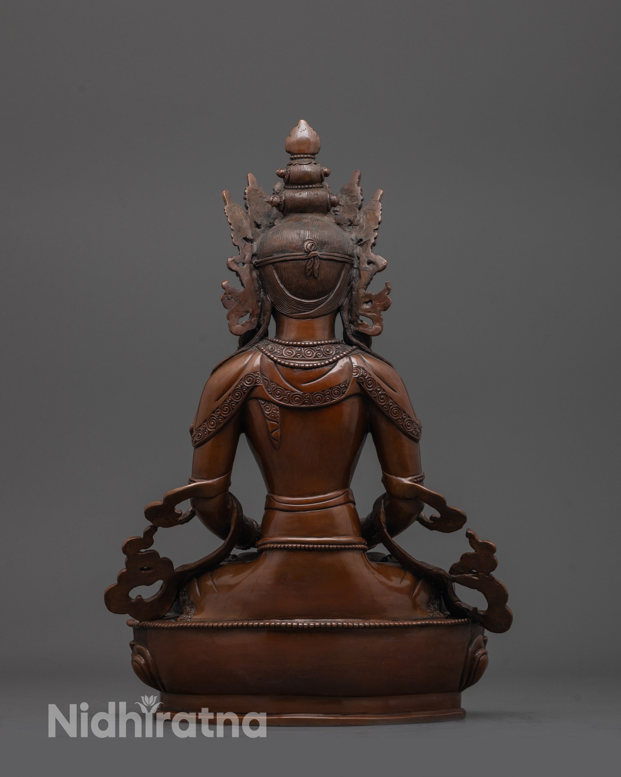 back view of oxidized Amitayus Buddha statue with intricate robe and base detailin