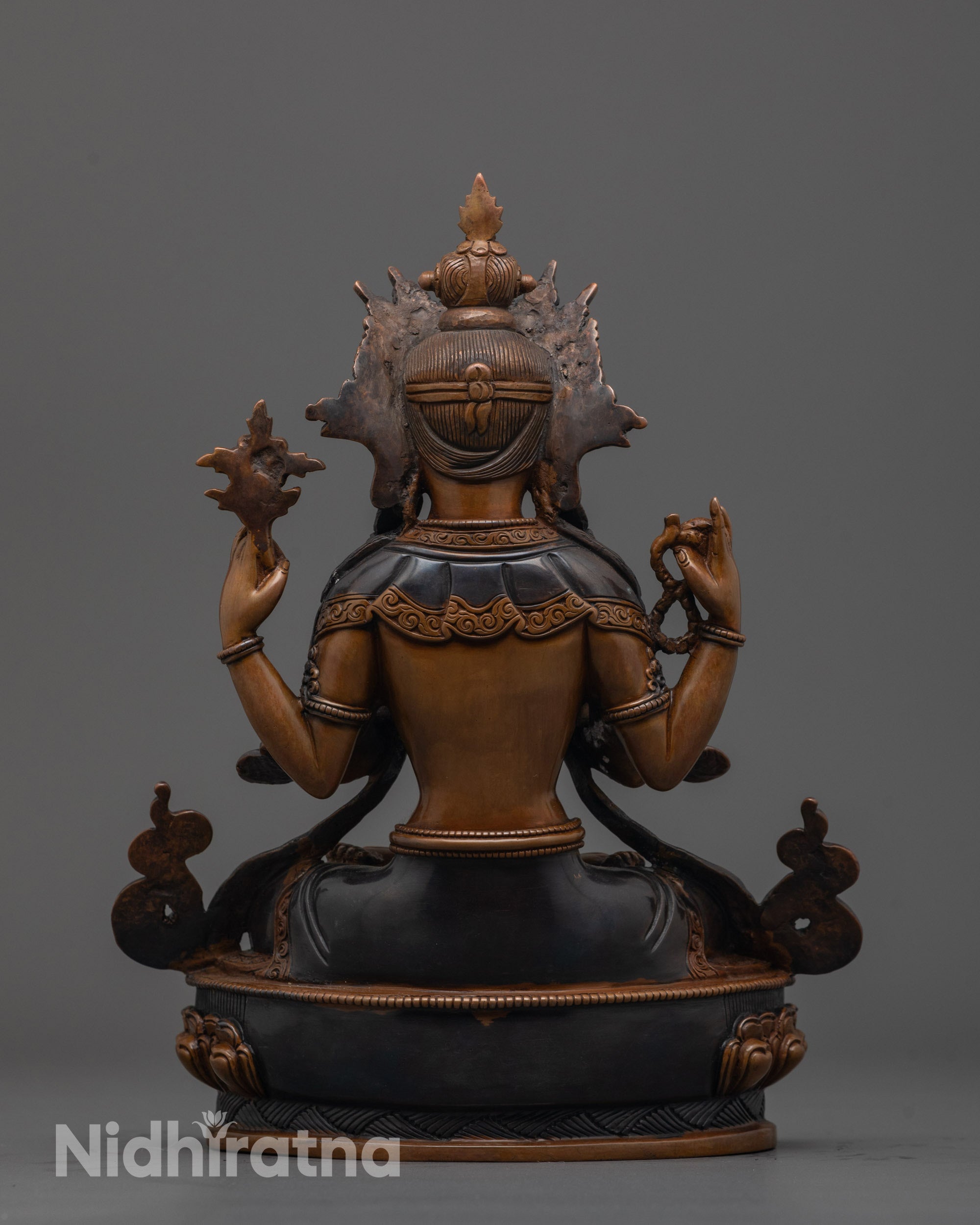 back view of oxidized Avalokiteshvara statue showing robe details and lotus throne design