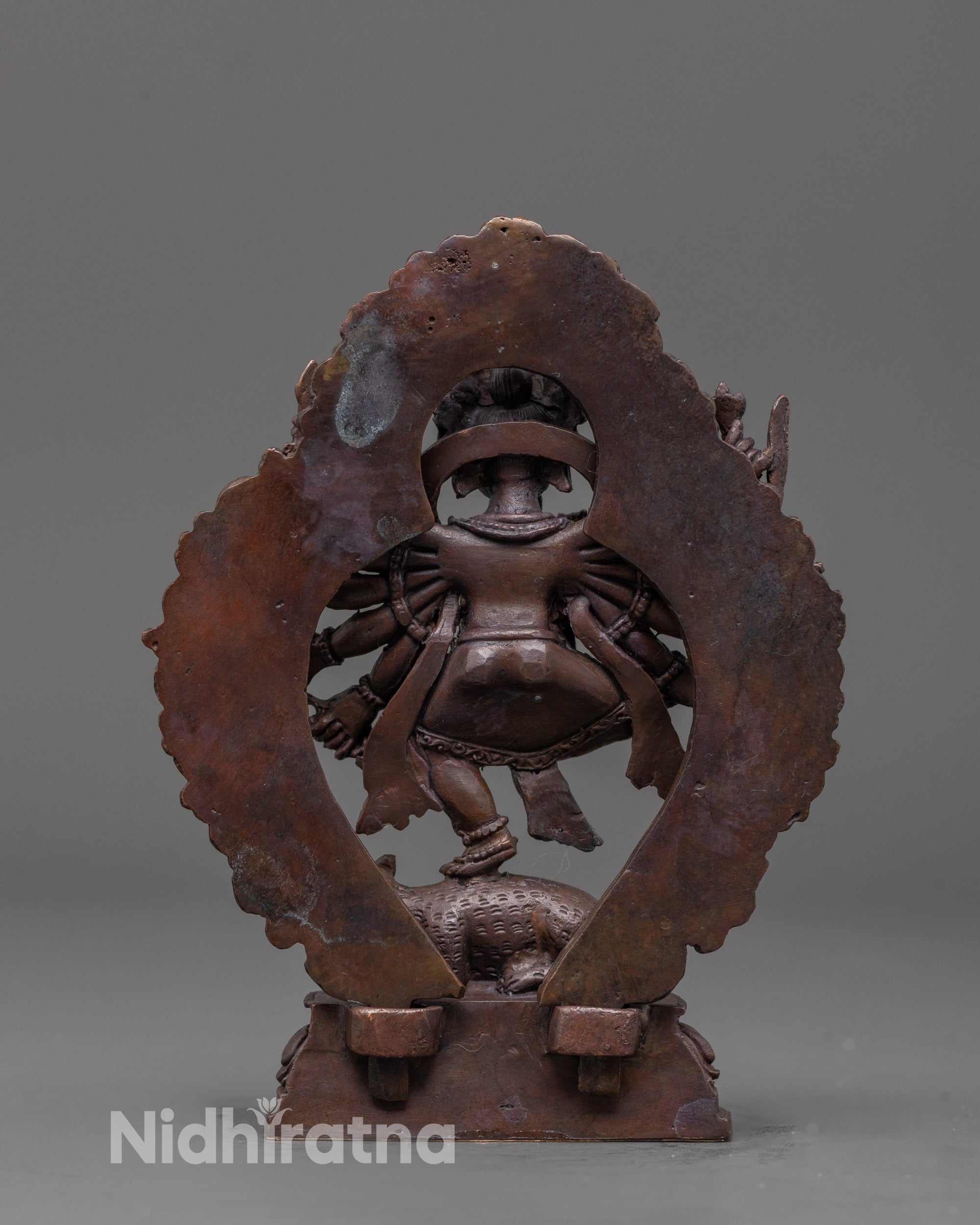 back view of oxidized Ganesha statue with halo and fine traditional carvings on robe