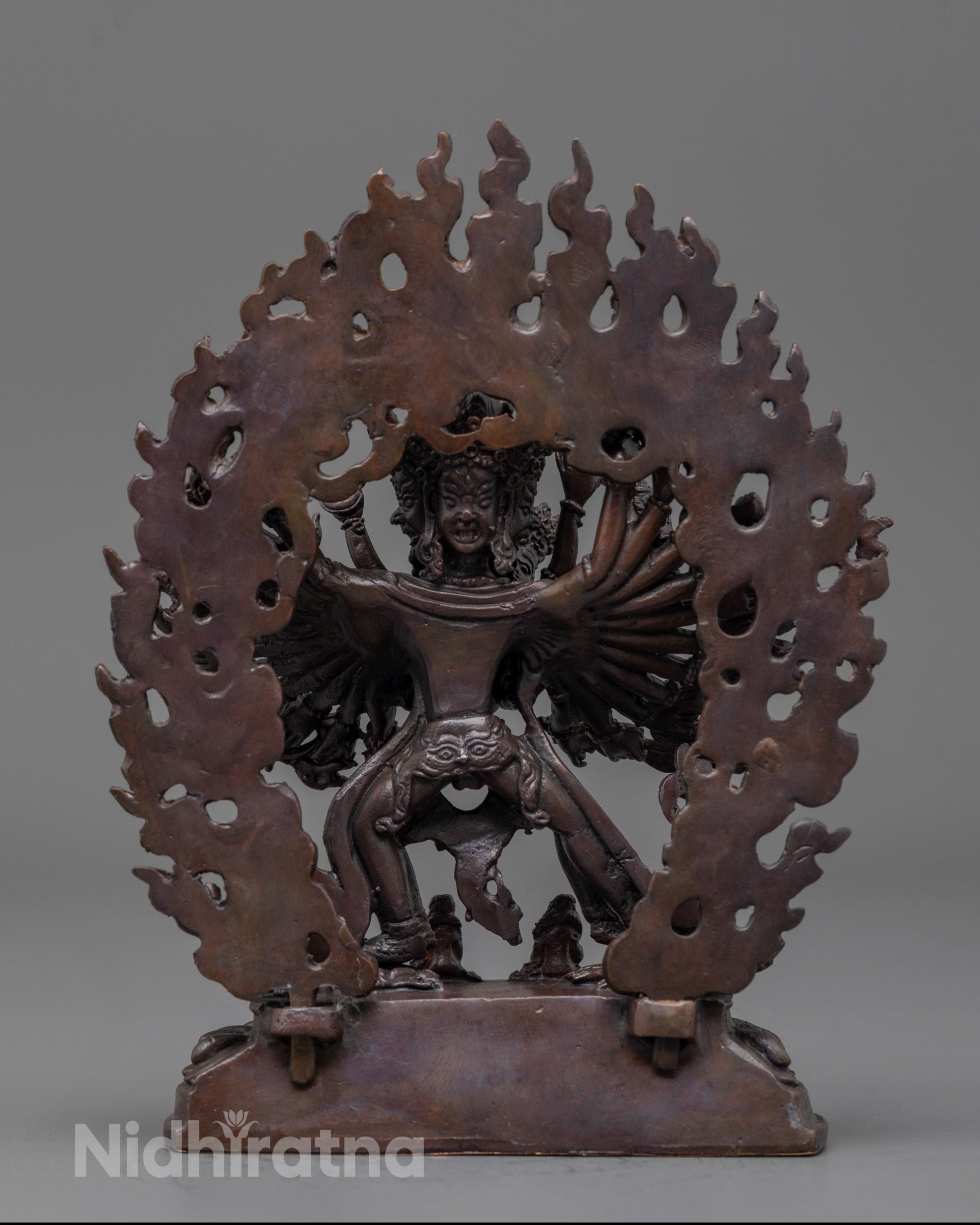 back view of oxidized Kalachakra statue highlighting detailed carving and sacred objects