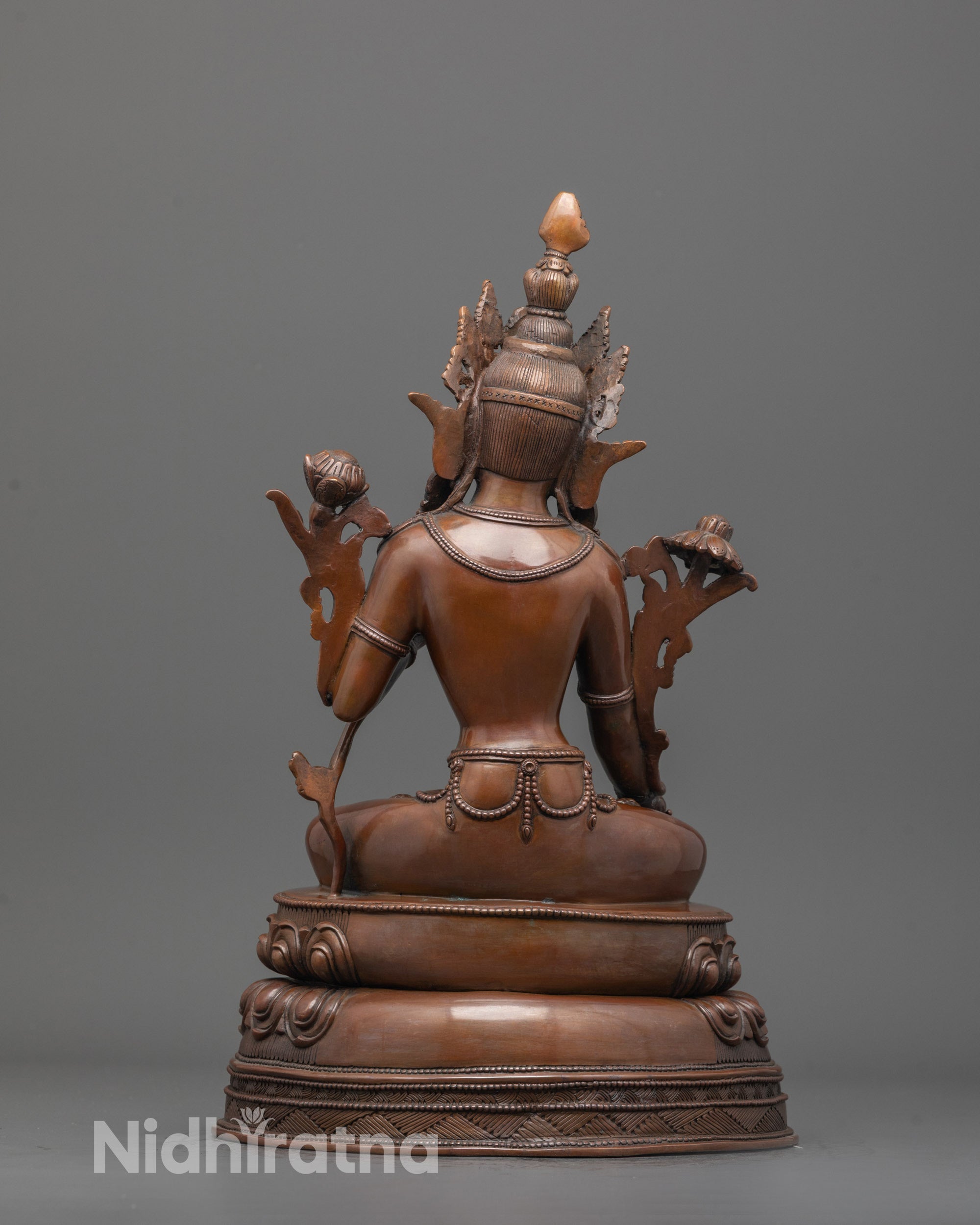back view of oxidized copper white tara statue showing fine carvings and traditional detailing