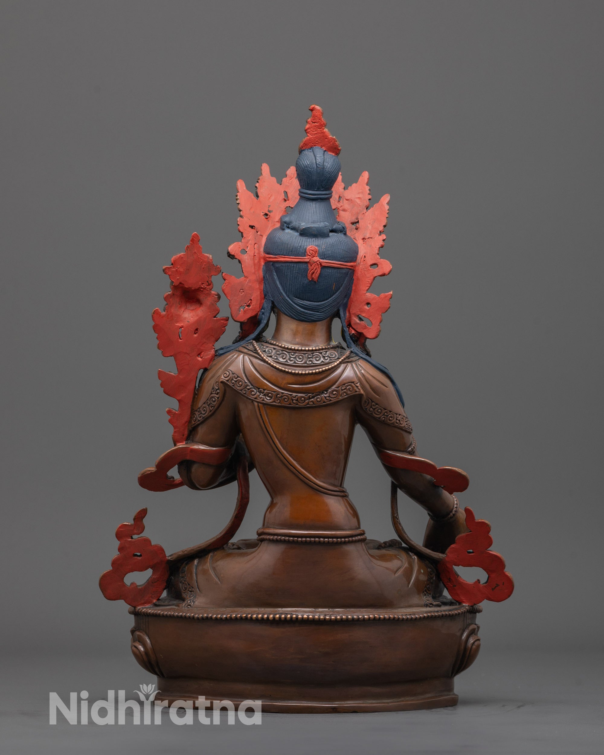 back view of oxidized copper white tara statue with intricate robe and all-seeing eye details