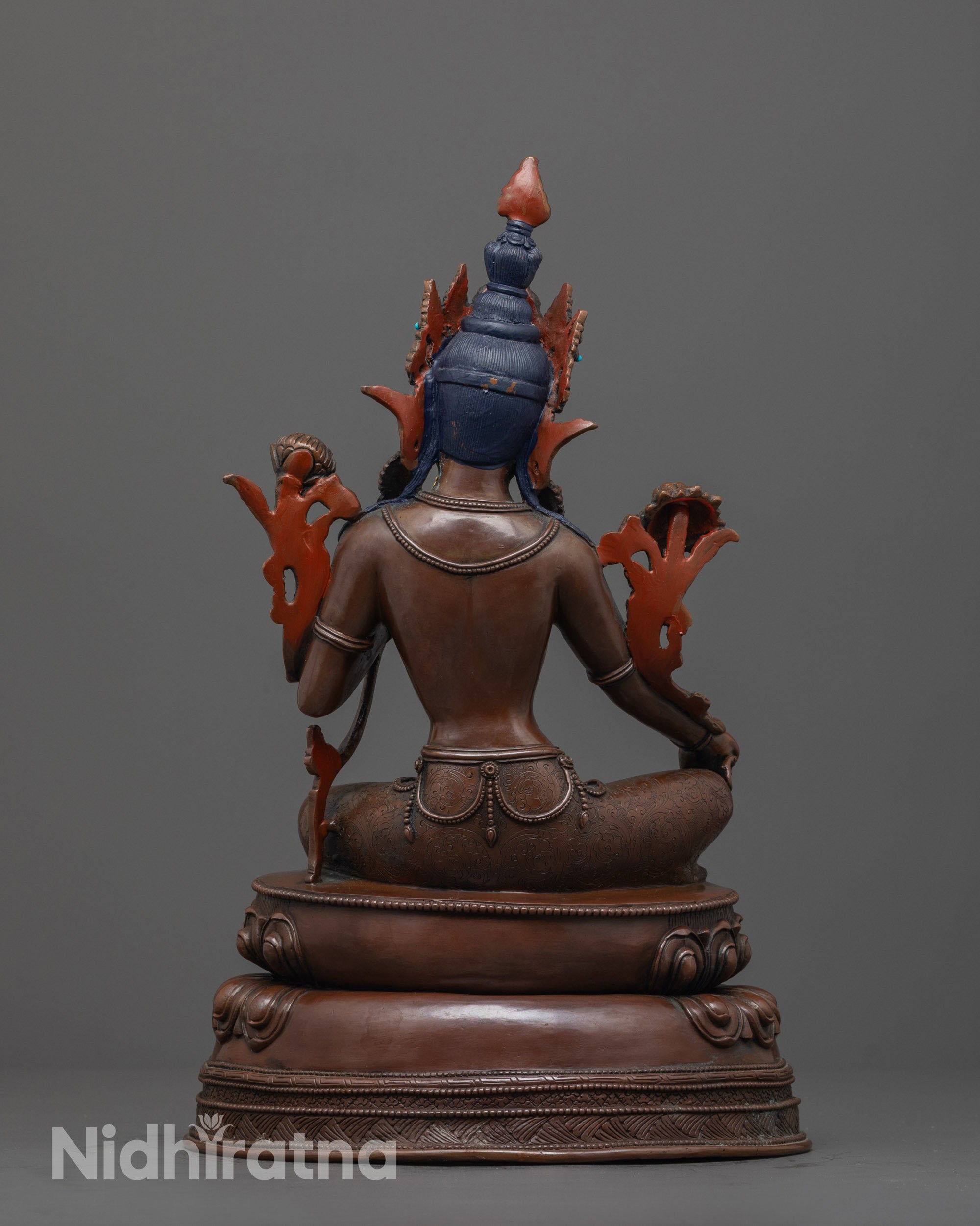 back view of oxidized green tara figurine with double-layered lotus seat and antique finish