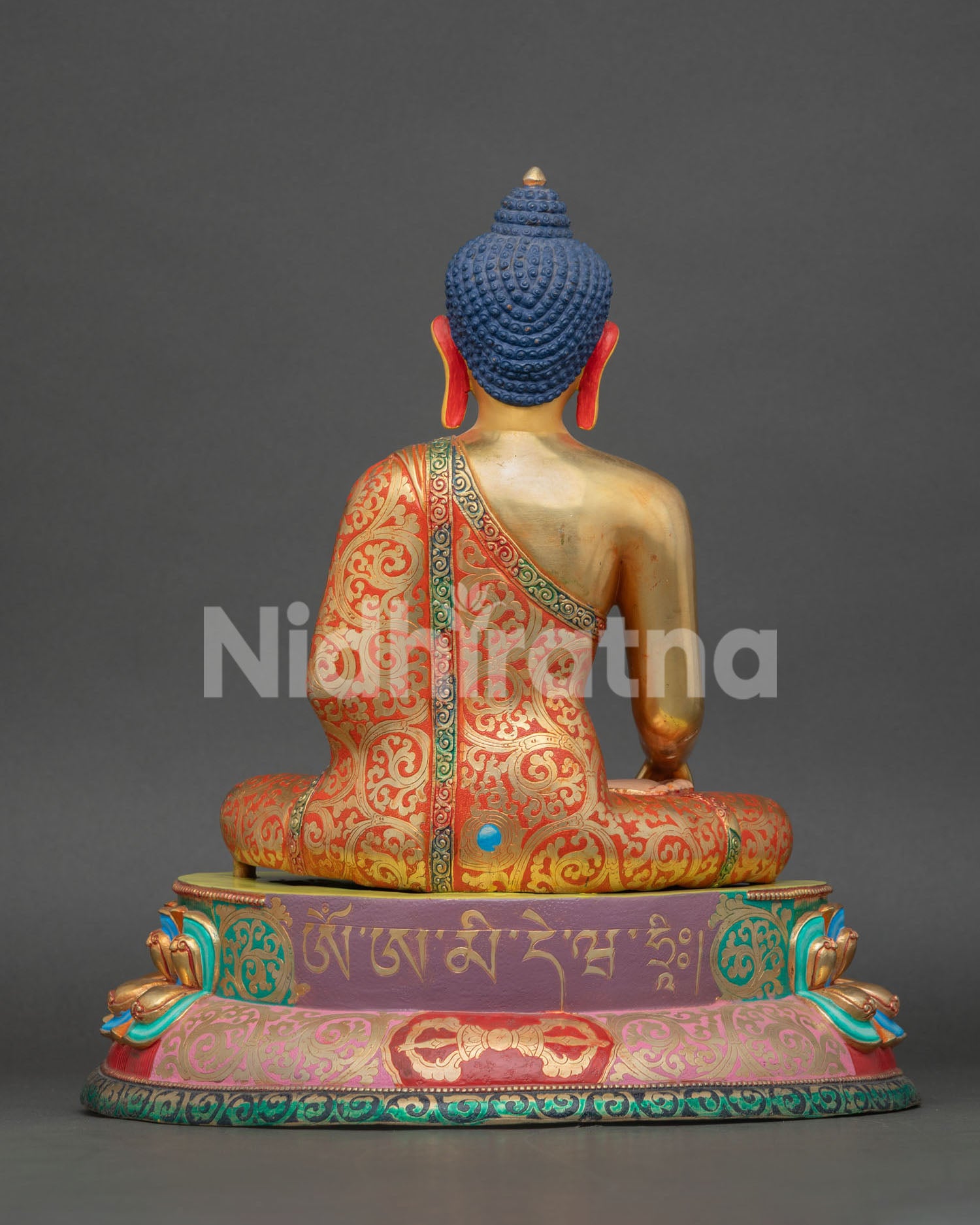 Back view of Shakyamuni Buddha sculpture with engraved sacred mantra on lotus seat and Himalayan craftsmanship