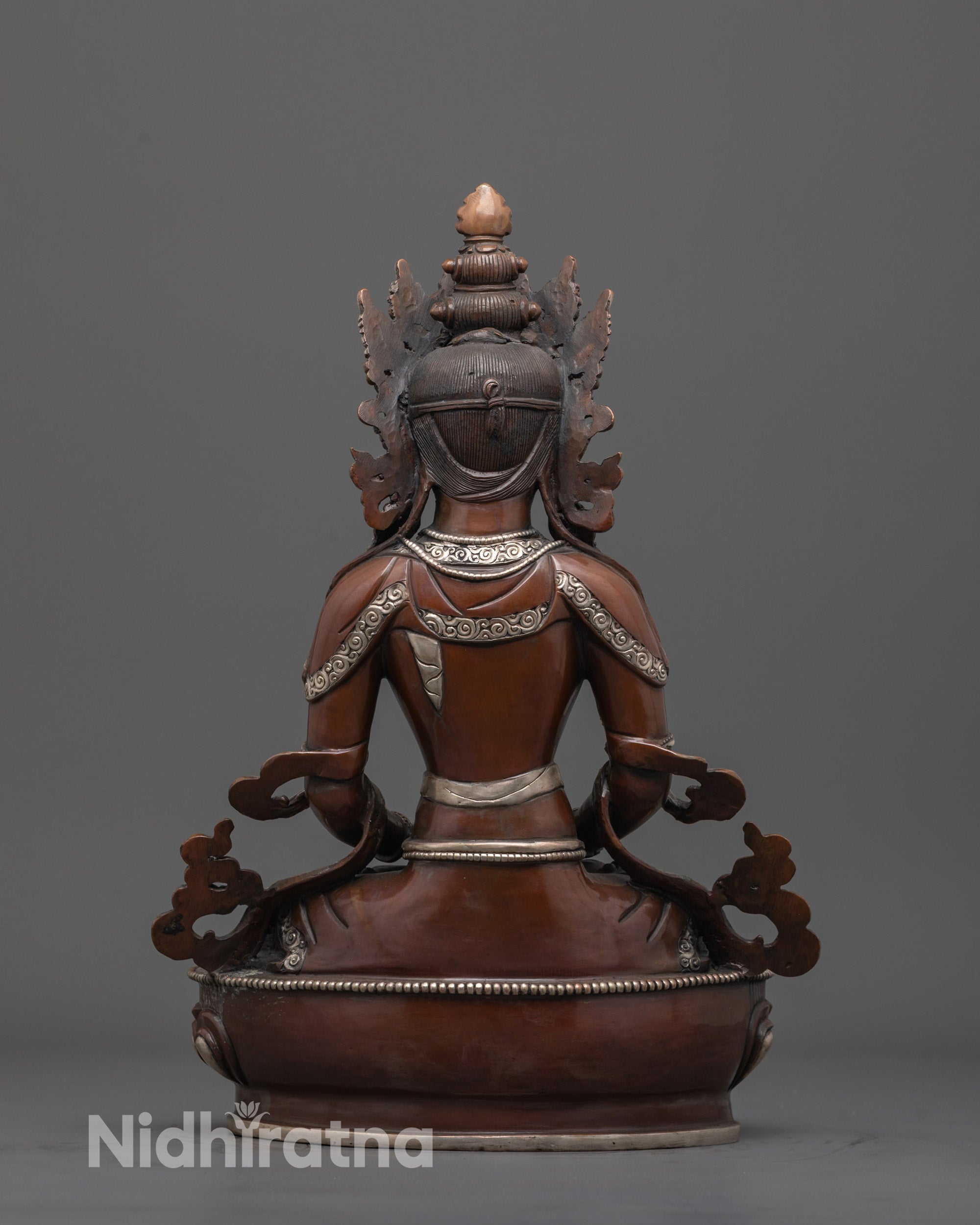 back view of silver-plated long life deity statue with detailed robe and oxidized copper finish