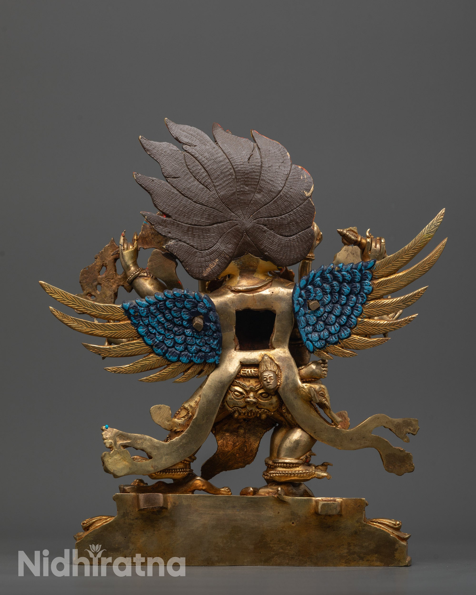 back view of vajrakilaya statue displaying wings, skull garland, and detailed garments