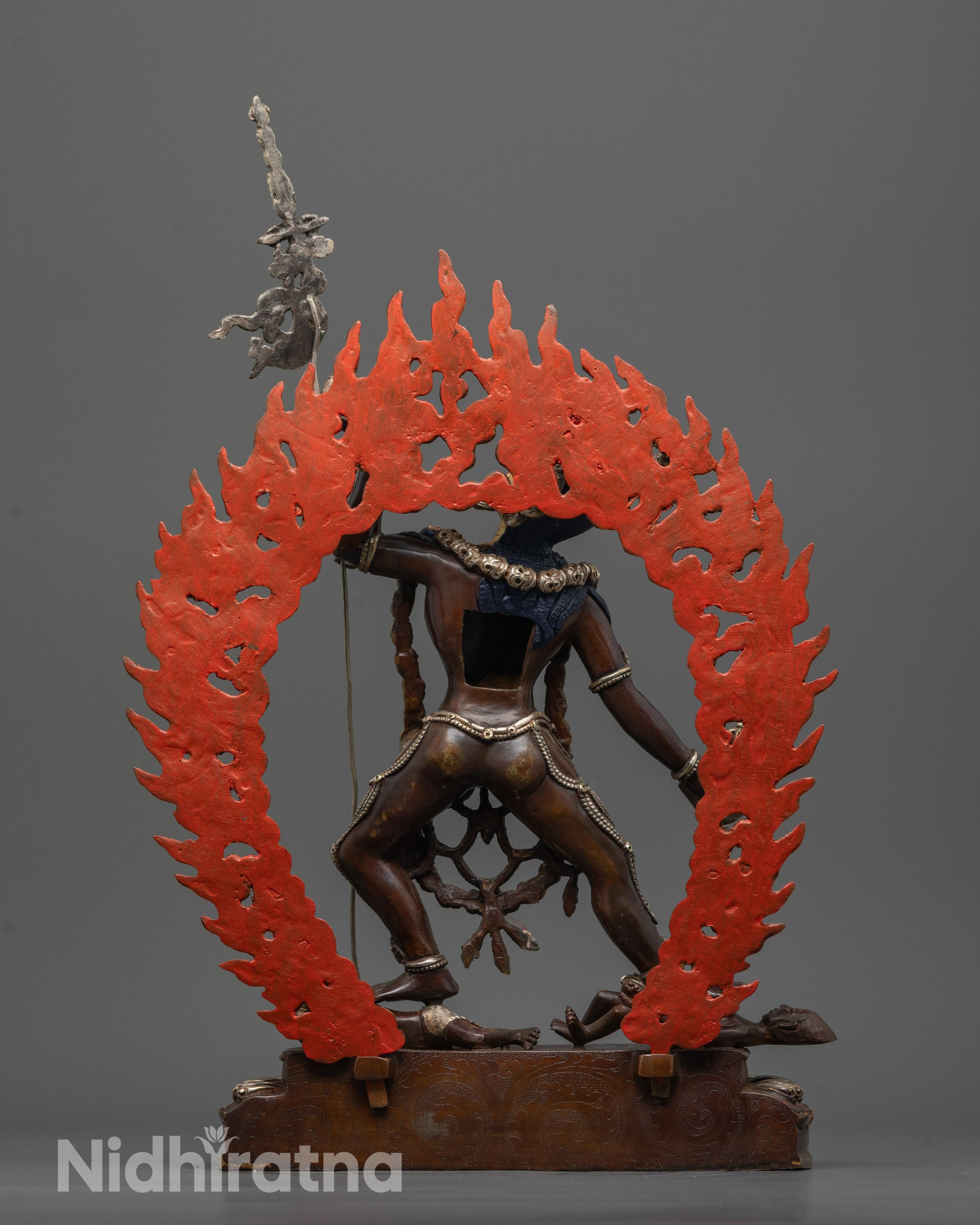 back view of vajrayogini statue with intricate flaming halo and silver-plated finish