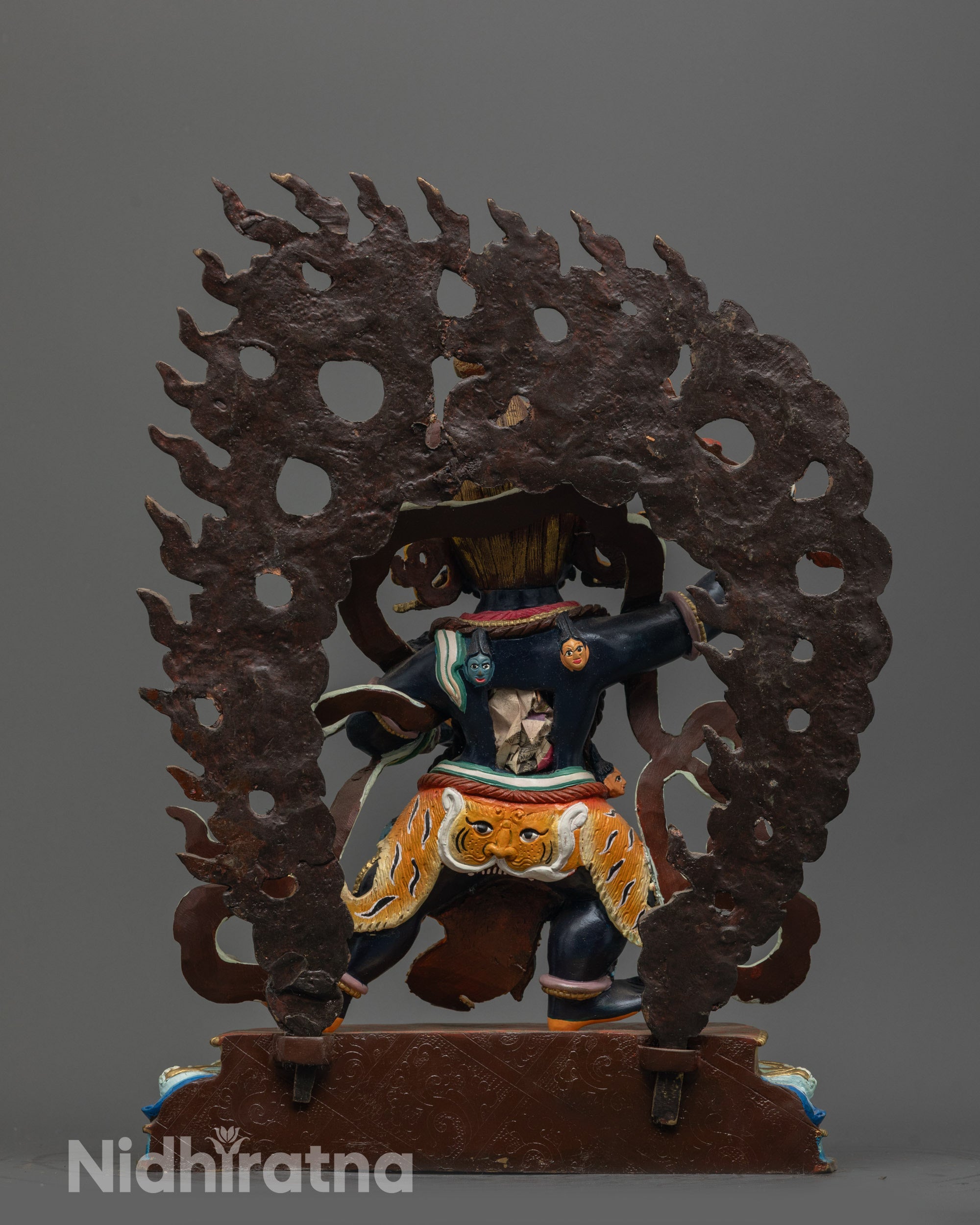 back view of wrathful manjushri statue showing detailed fire halo and skull garland