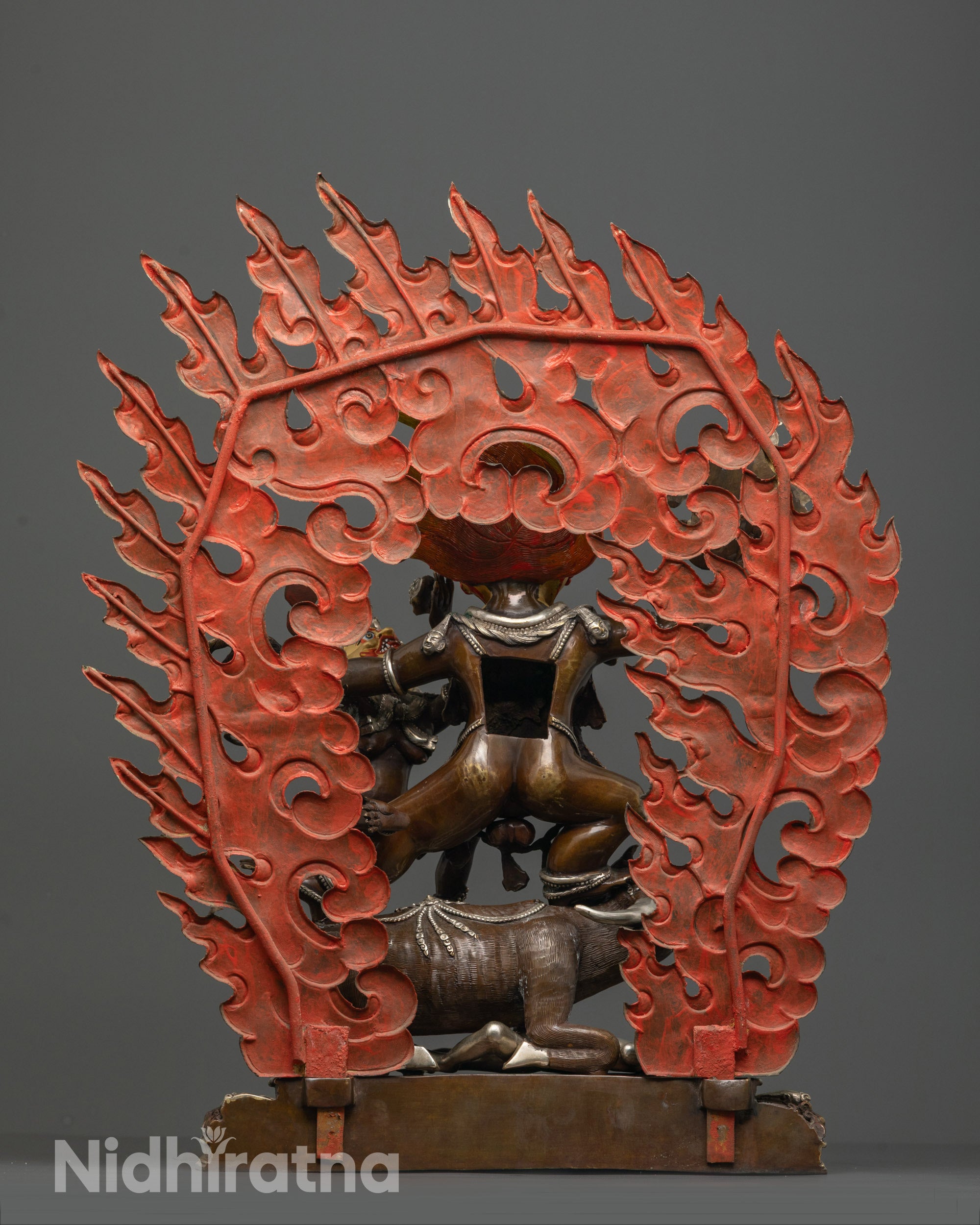 back view of yamantaka consort statue highlighting intricate halo and aged copper finish