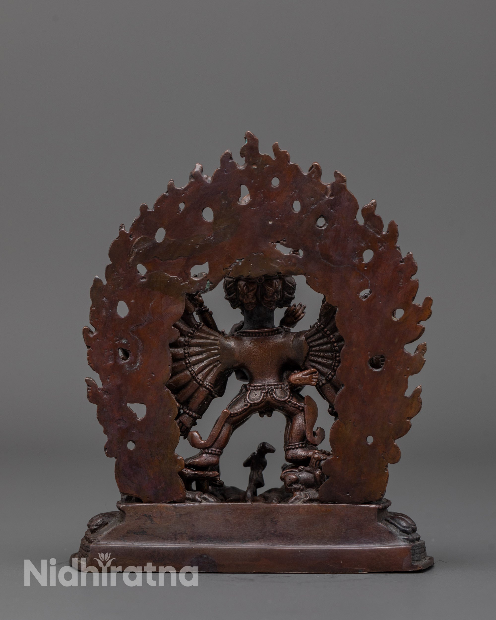 back view of yamantaka statue highlighting radiant halo and intricate copper carvings
