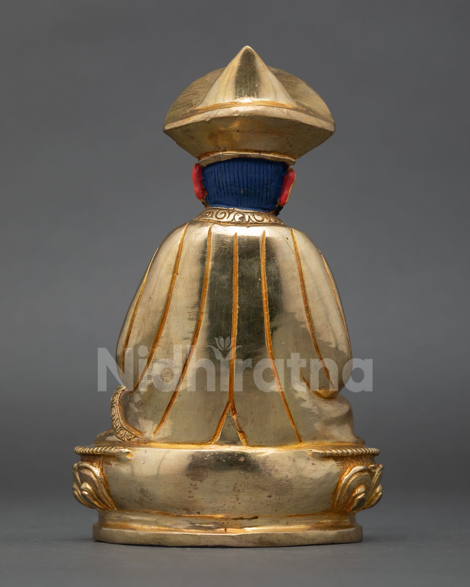 Bhutanese Buddhist leader statue highlighting flowing robes lotus seat and Himalayan artisan metalwork