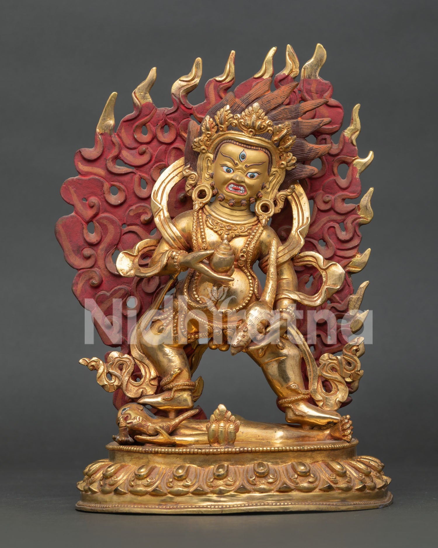 Black Dzambhala statue from Nepal with gold gilded copper body and powerful wrathful expression