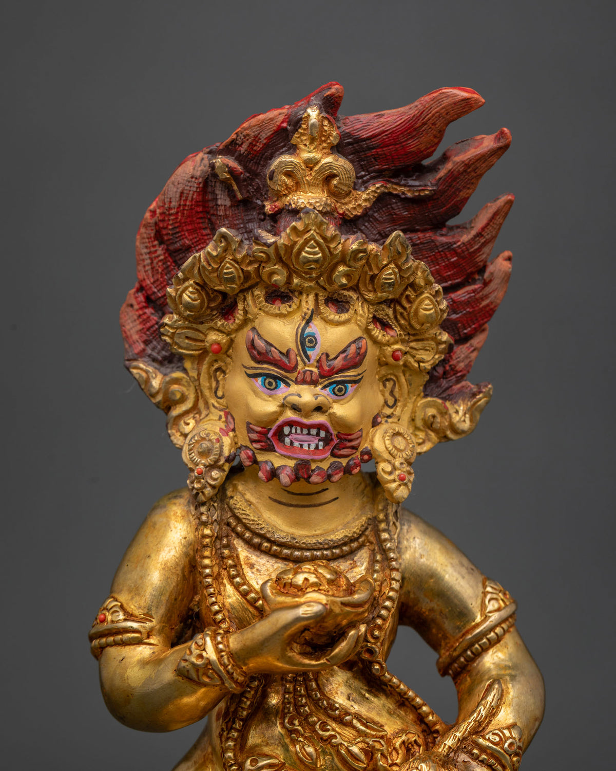Black dzambhala statue gold fire gilded copper with 24k gold painted face.