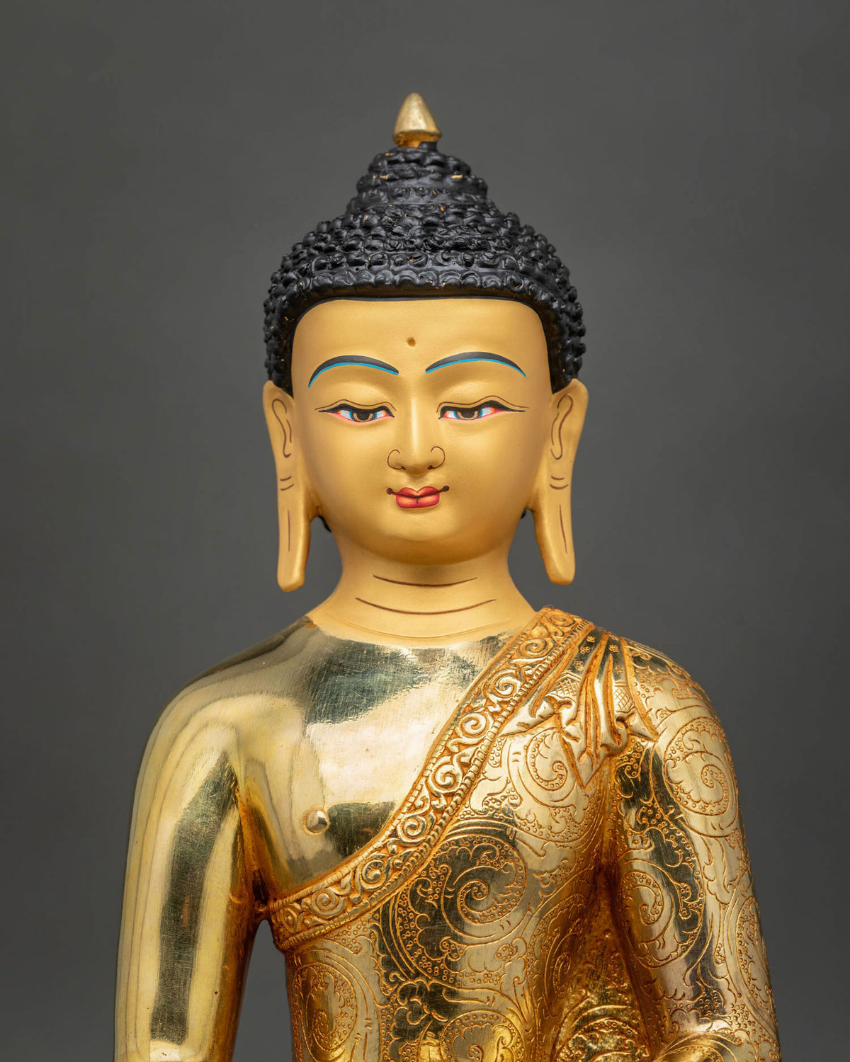Buddha Shakyamuni Statue featuring a peaceful, serene gold-painted face, and radiant 24K gold fire-gilding.
