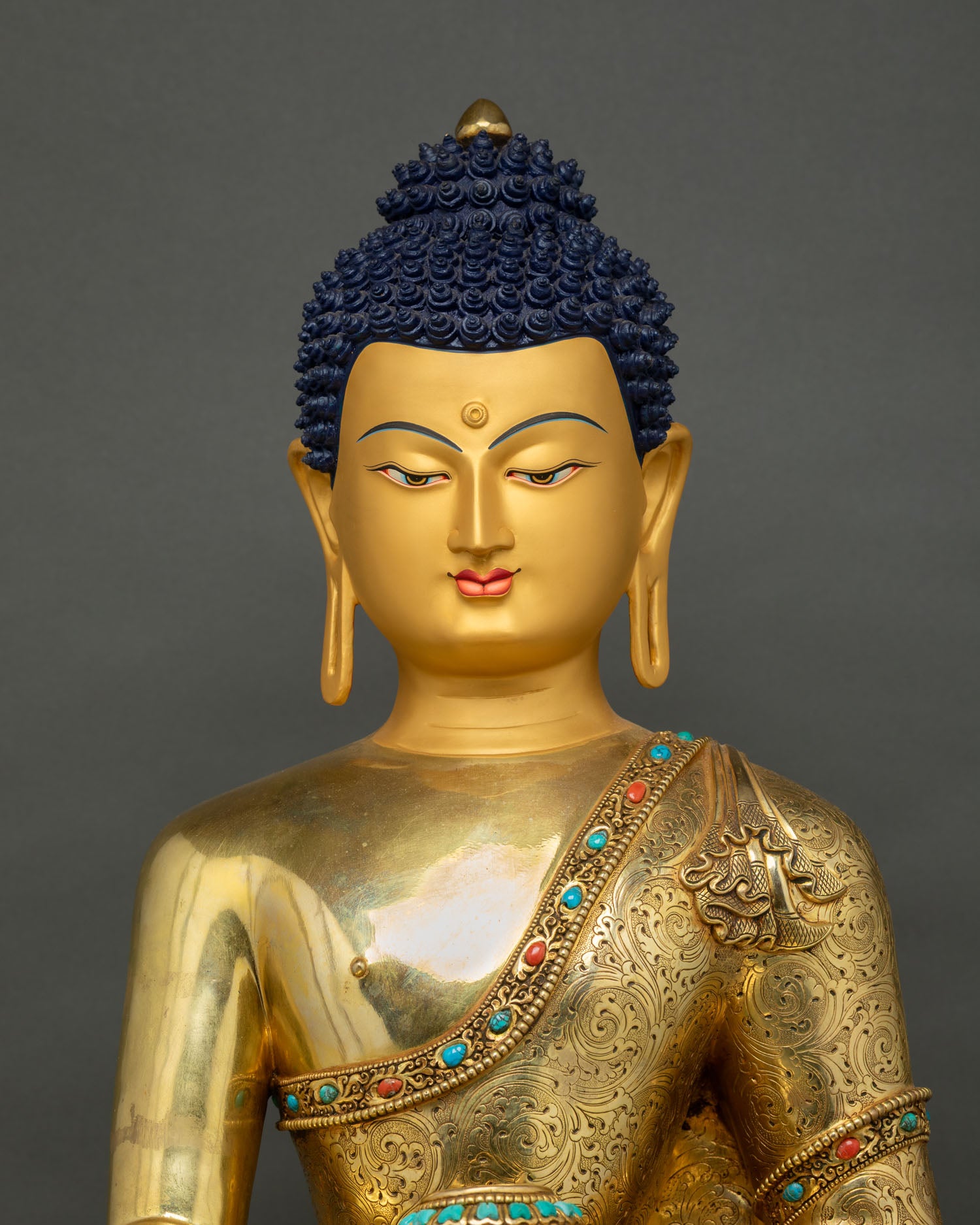 Buddha Shakyamuni Statue head close-up showing blue curled hair and serene face profile