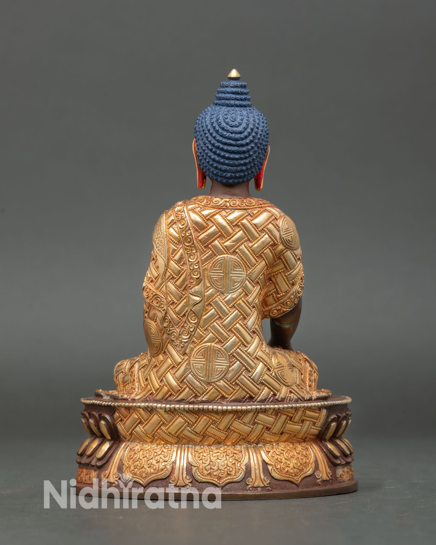 Buddha statue with flowing gilded robes and refined detailing, handcrafted Nepalese Buddhist artwork for sacred home decor and spiritual space.