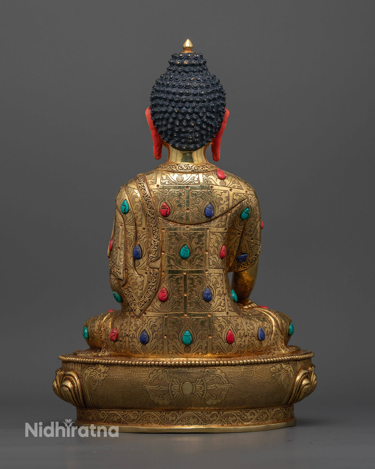 Buddhist Shakyamuni statue with ornate floral carvings and radiant gold finish symbolizing wisdom compassion and enlightenment.