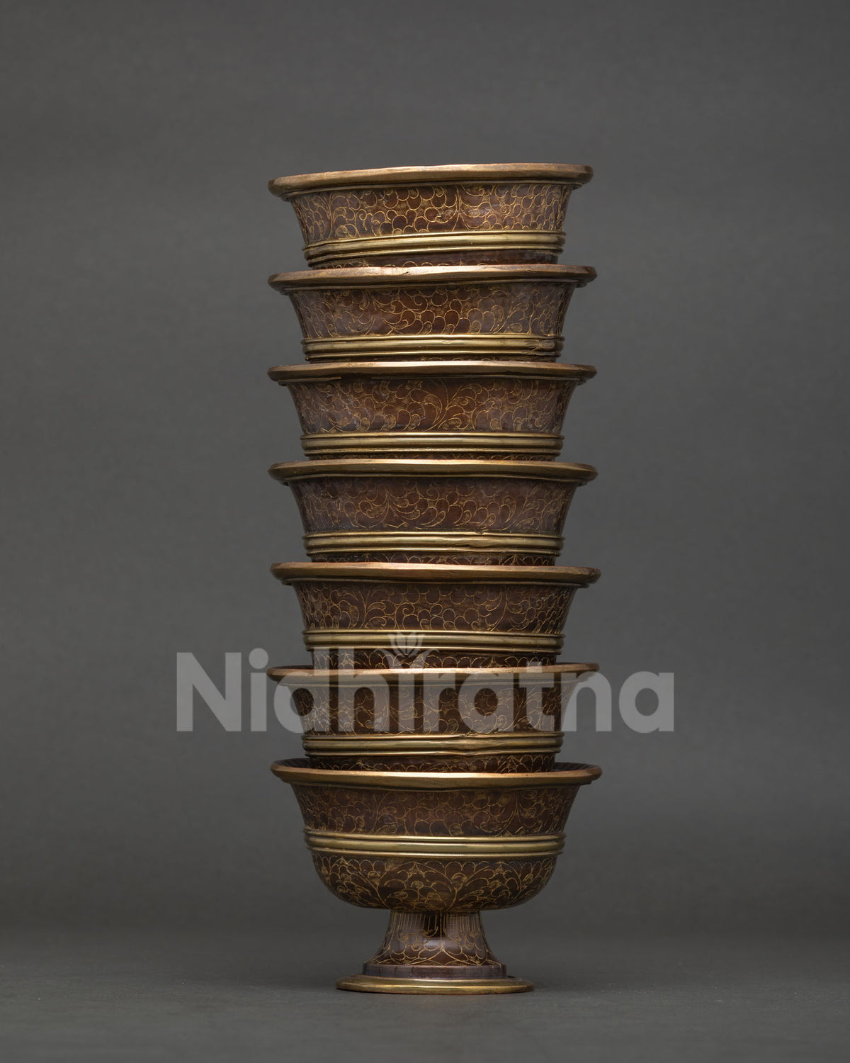 Buddhist Water offering bowl with intricate engraved floral motifs.