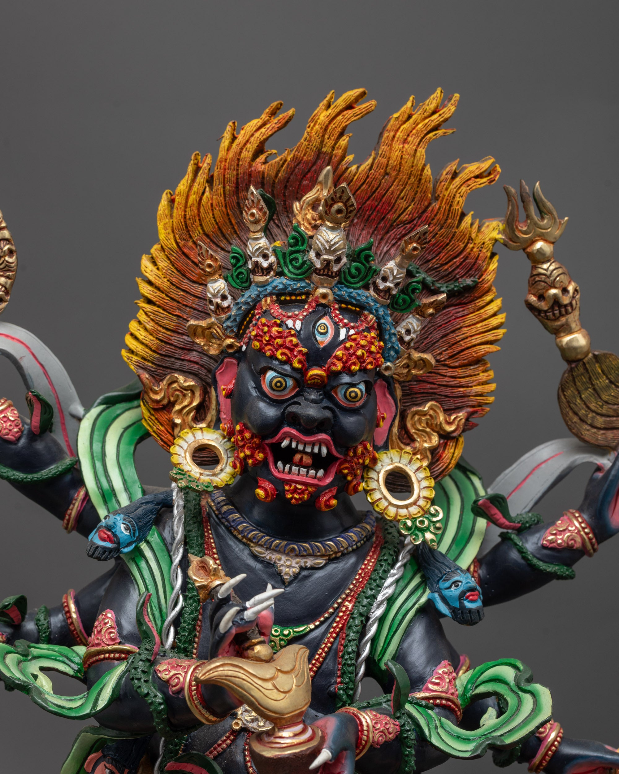 Close up of Six-Armed Mahakala Statue showing painted face and intricate detailing