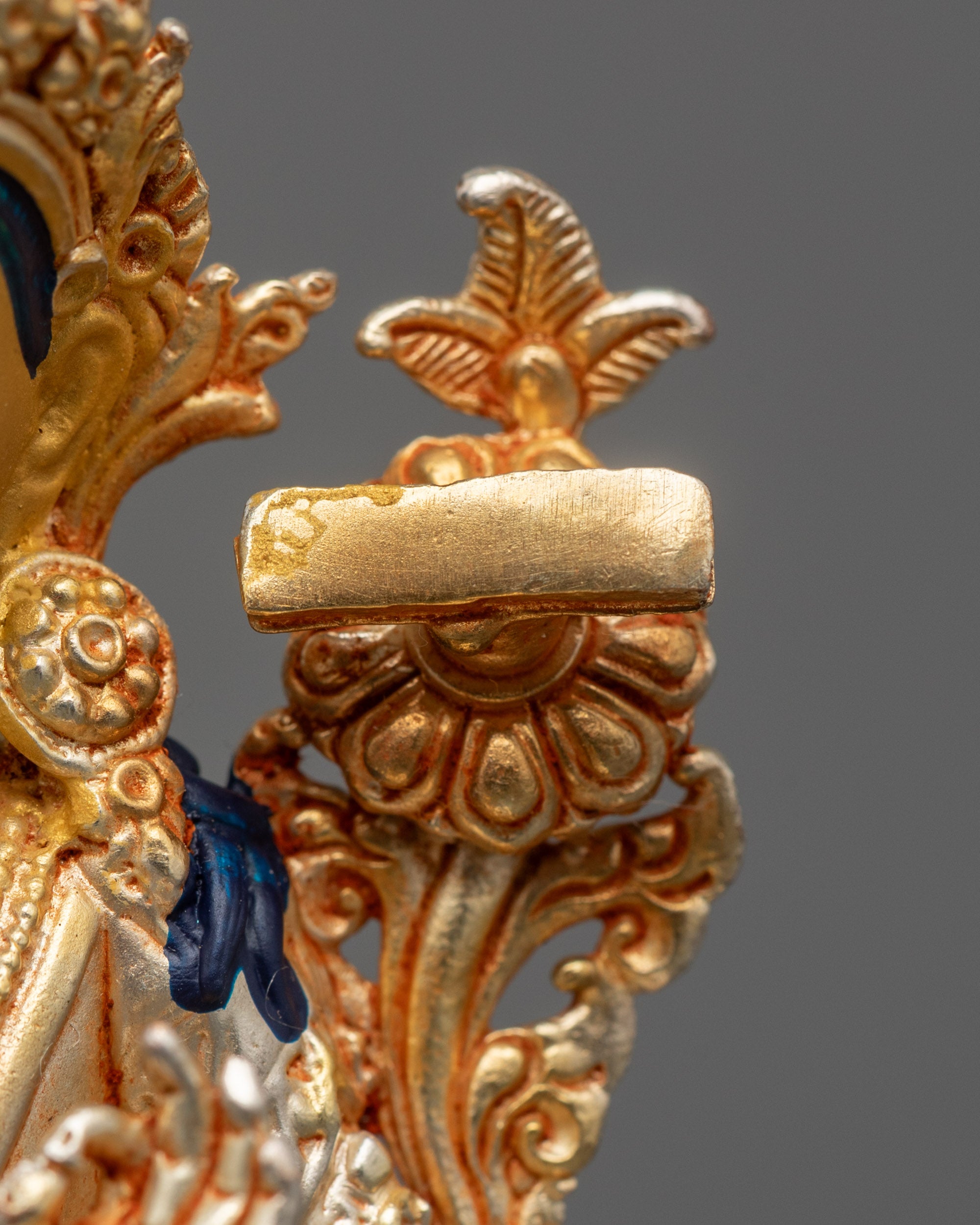 Detailed view of electroplated Manjushri statue with gold and silver finish