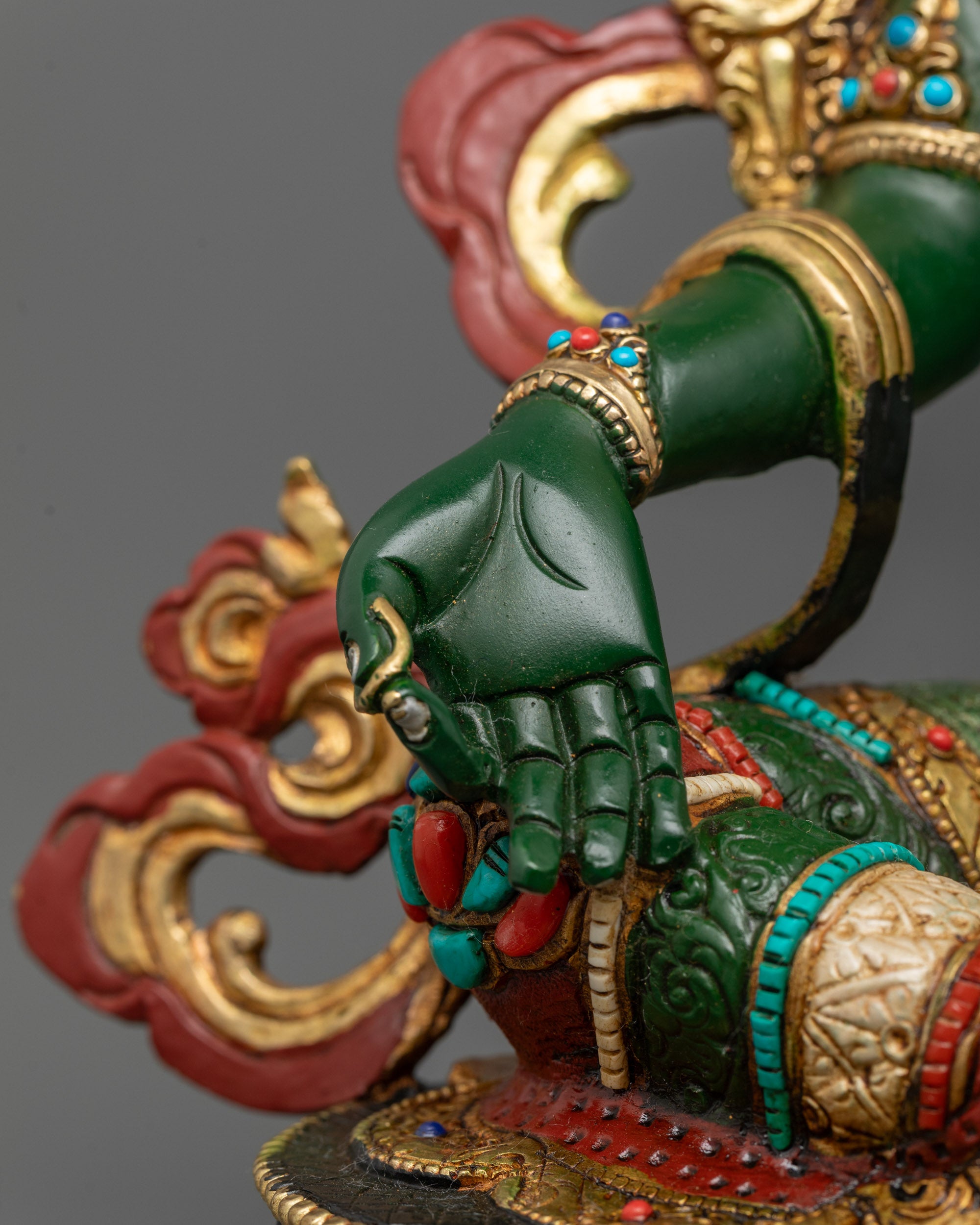 Detailed shot of lotus base and intricate gold-plated features on copper Green Tara Statue