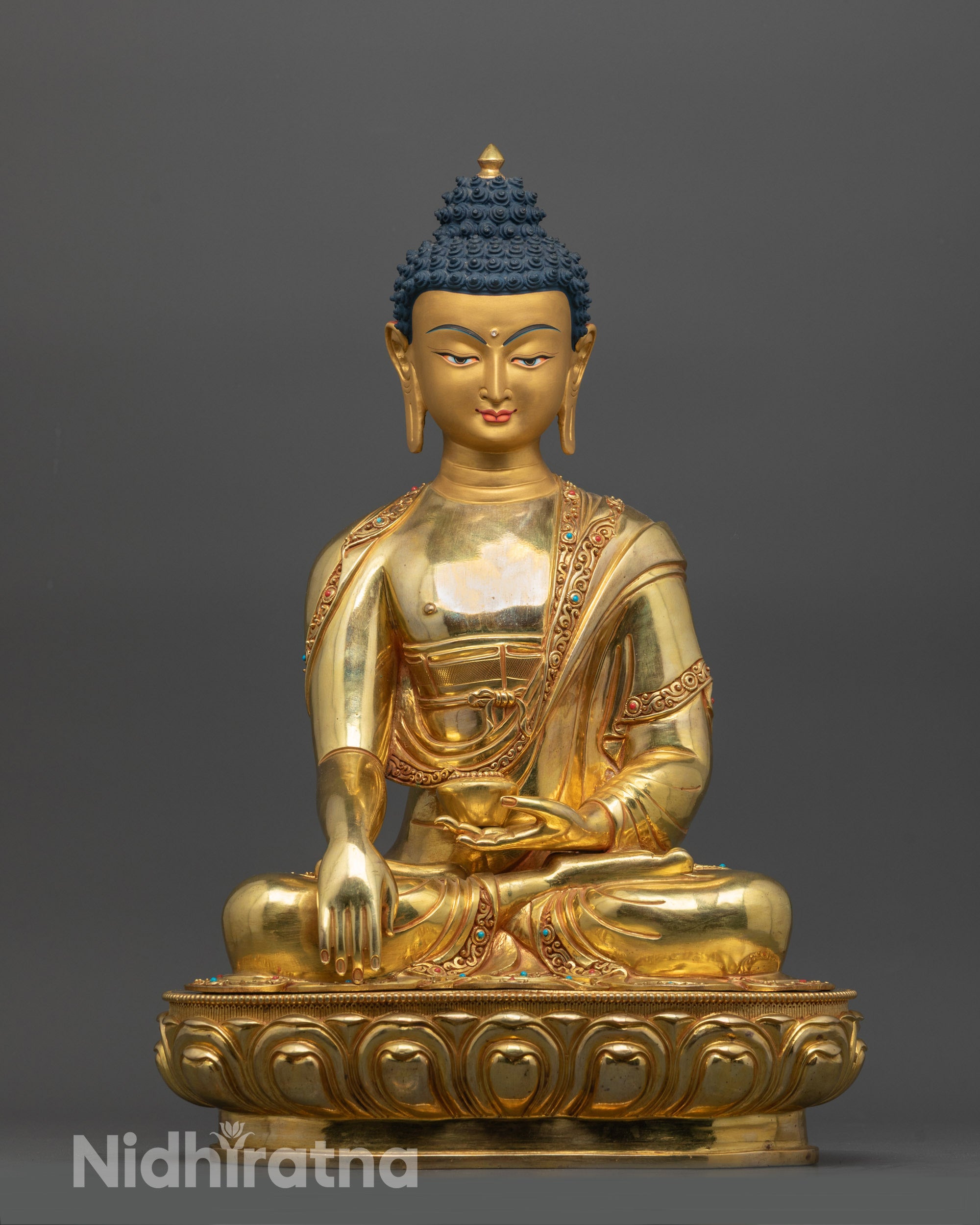 Front view of premium Shakyamuni Buddha statue with gold-gilded face and lotus seat detail