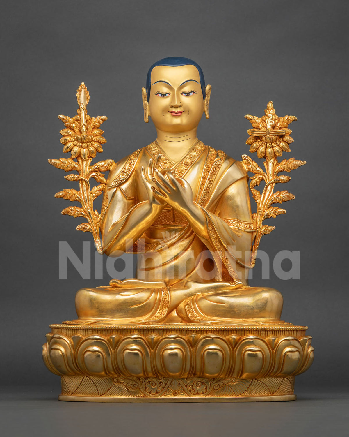 Central Je Tsongkhapa with hands at his heart, framed by gilded flowering stems and a serene smile