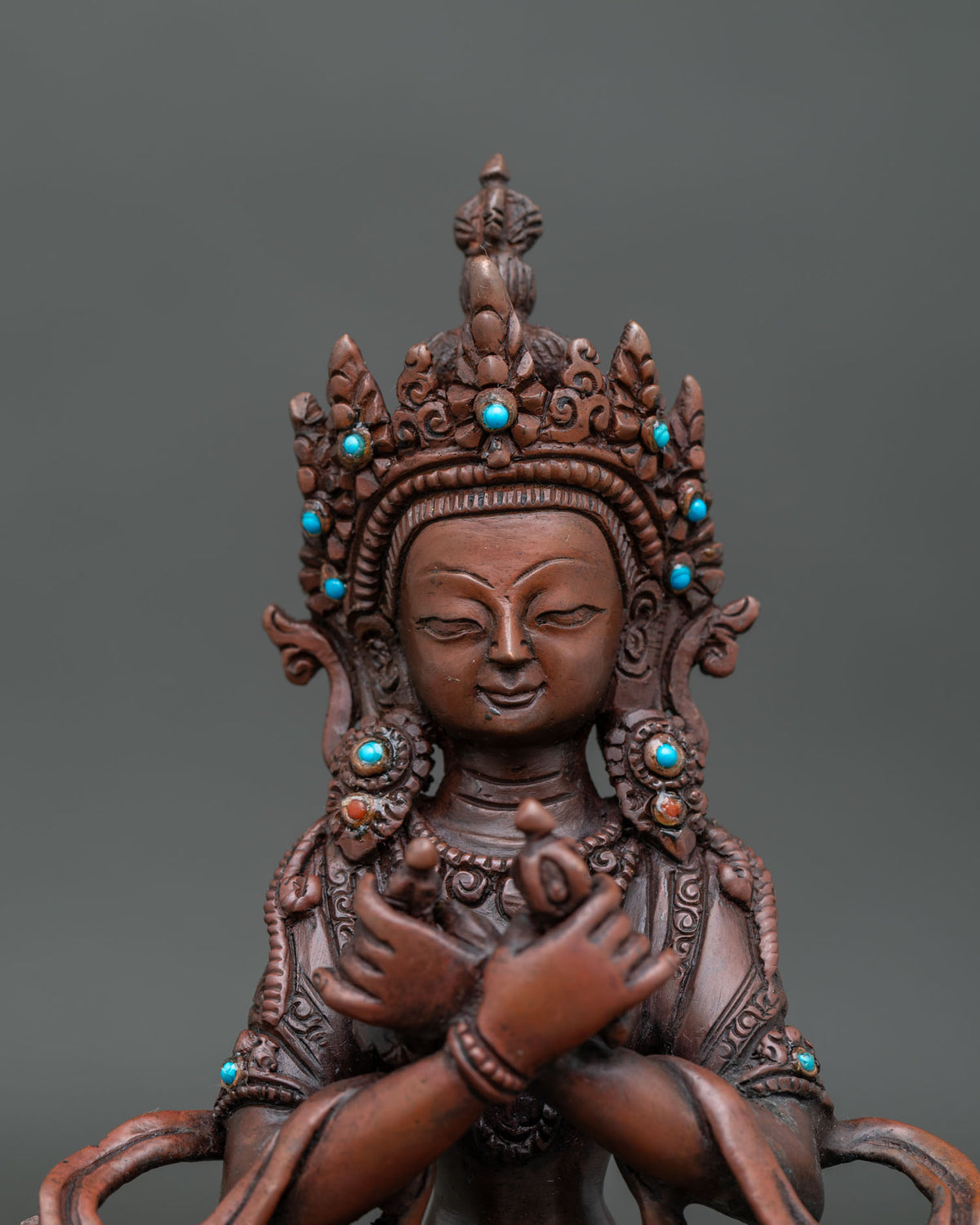 Chemically oxidized vajradhara statue with intricate details and sacred adornments.