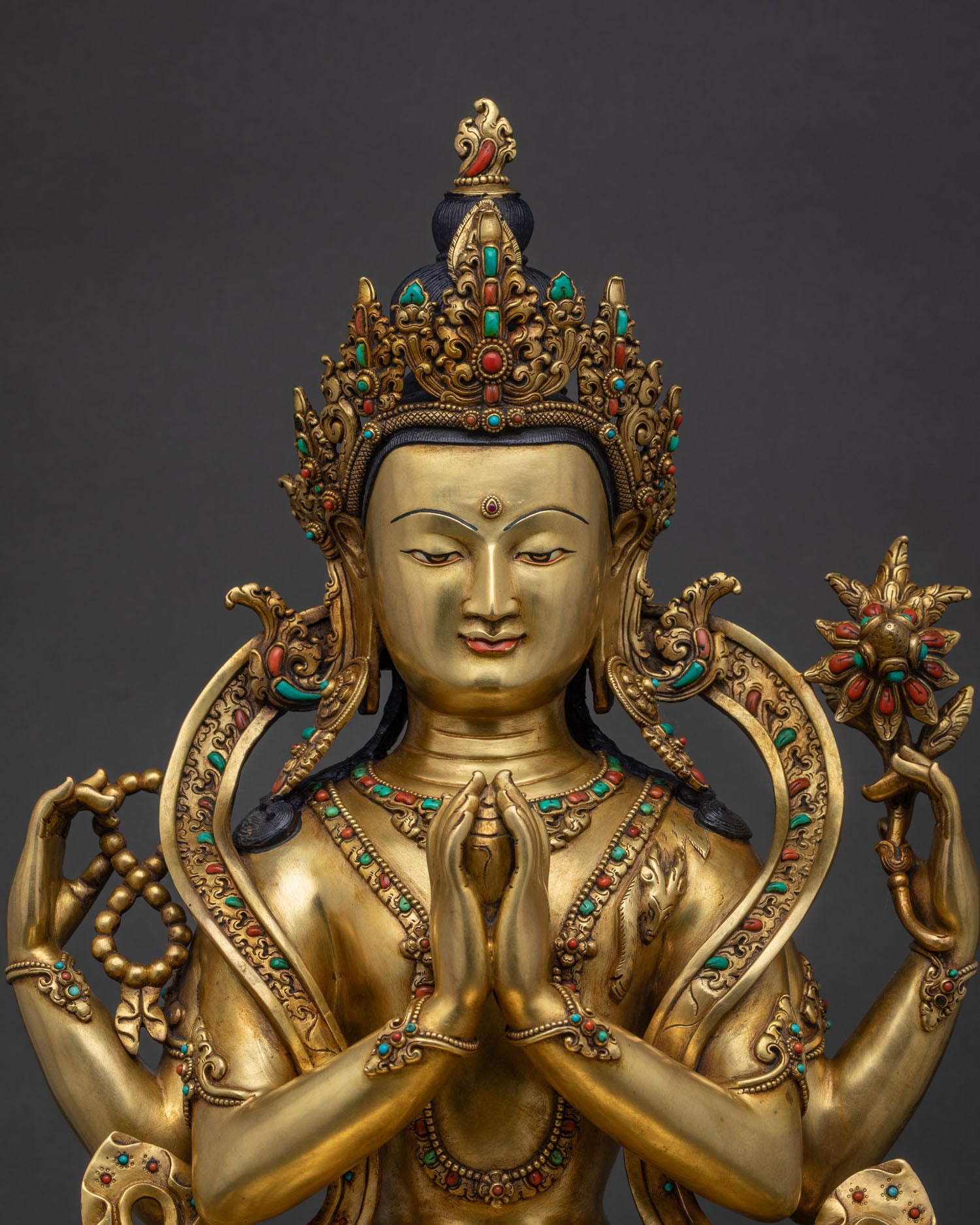 chenrezig avalokiteshvara statue close up 24k gold gilded copper with turquoise and coral inlay nepal