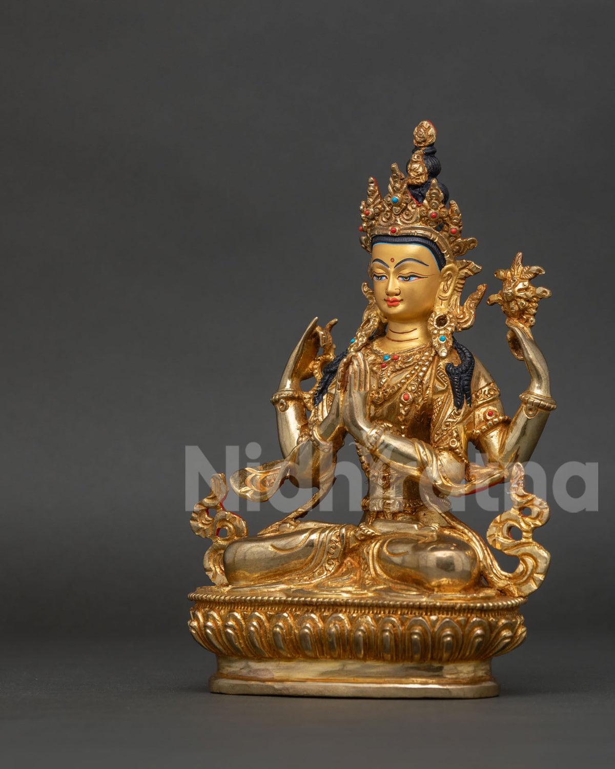 Chenrezig bodhisattva of compassion holding lotus flower and mala on detailed lotus pedestal.