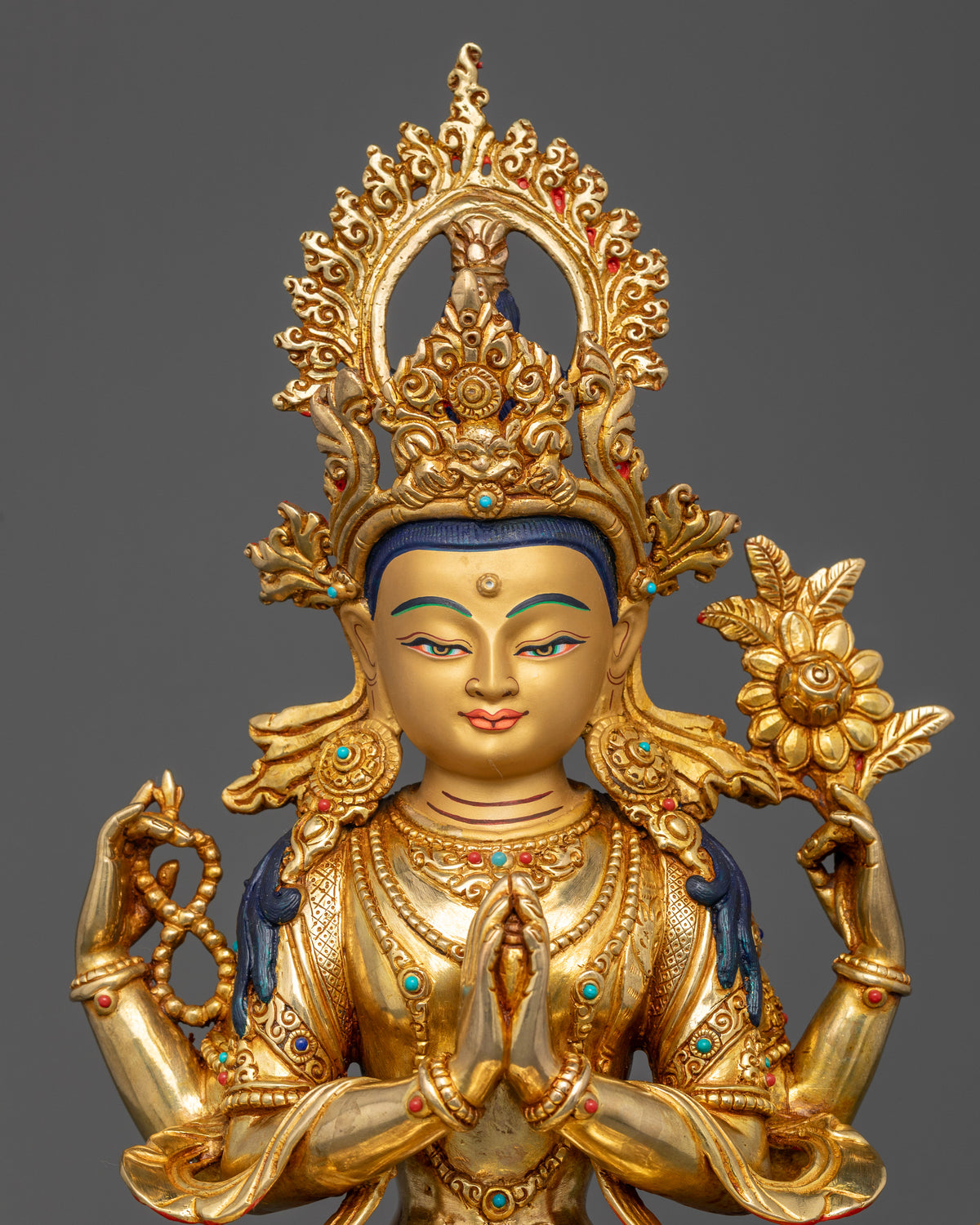Chenrezig Bodhisattva of Compassion statue with gold-painted face, semi-precious stones, and radiant halo.