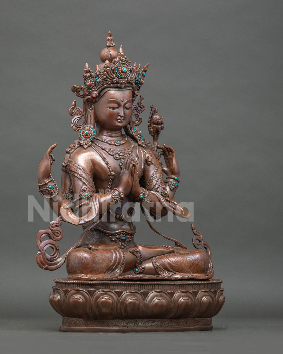Chenrezig buddhist statue seated on hand carved lotus pedestal with semi precious stones.