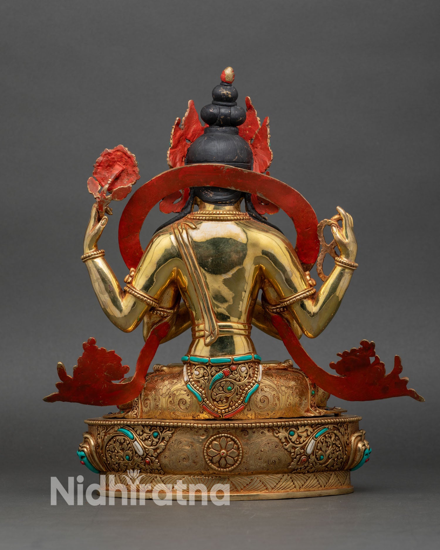 Chenrezig statue back view showing halo, ornaments, and lotus base