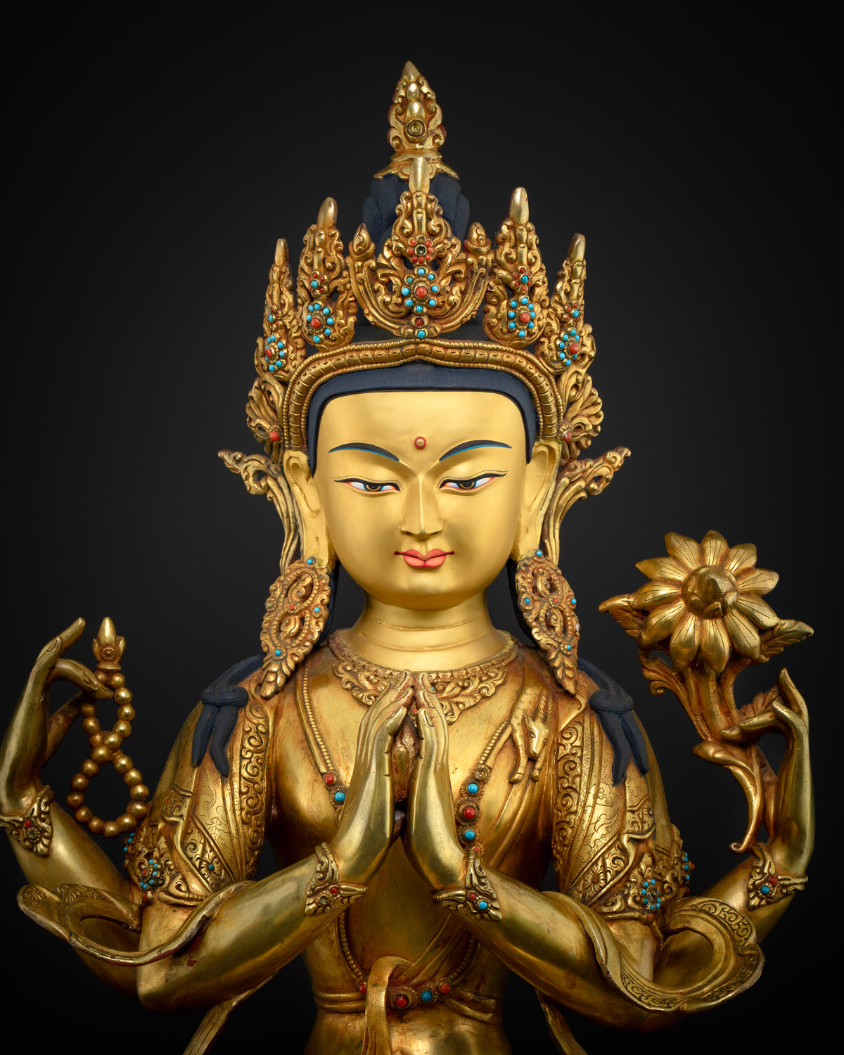 Chenrezig statue close-up, gold gilding and turquoise inlay detail