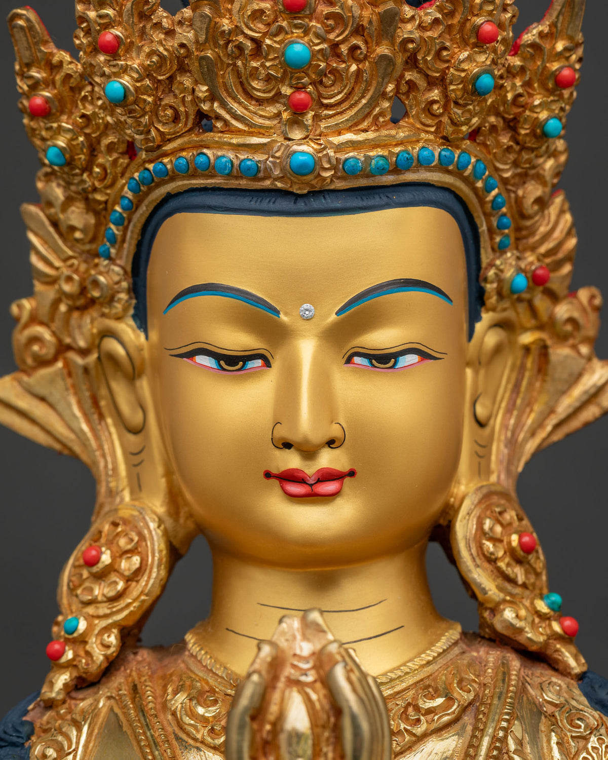 Chenrezig Statue face close up 24k gold painted face and jewelry.