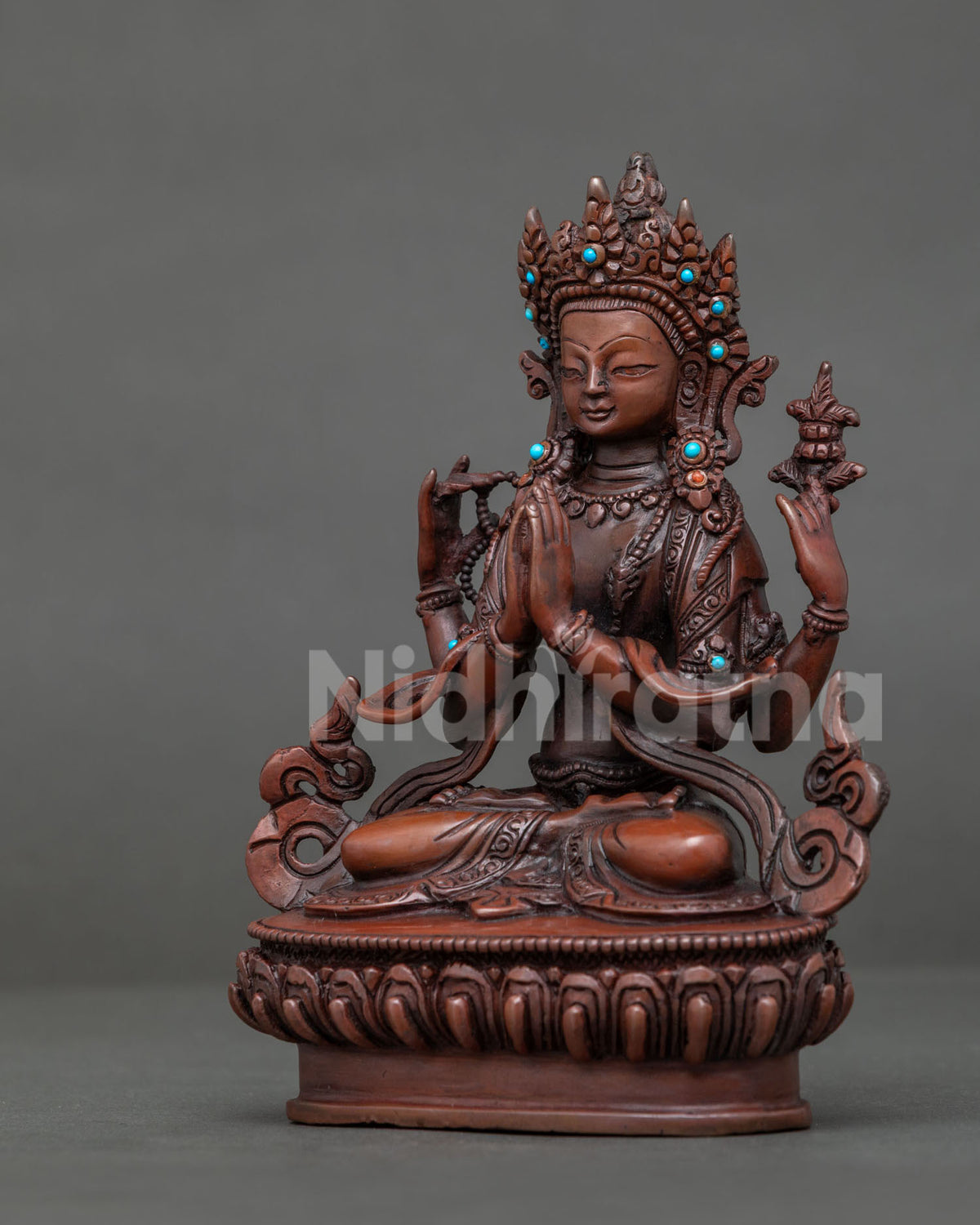 Chenrezig statue holding utpala flower with semi precious stones and jeweled crown.