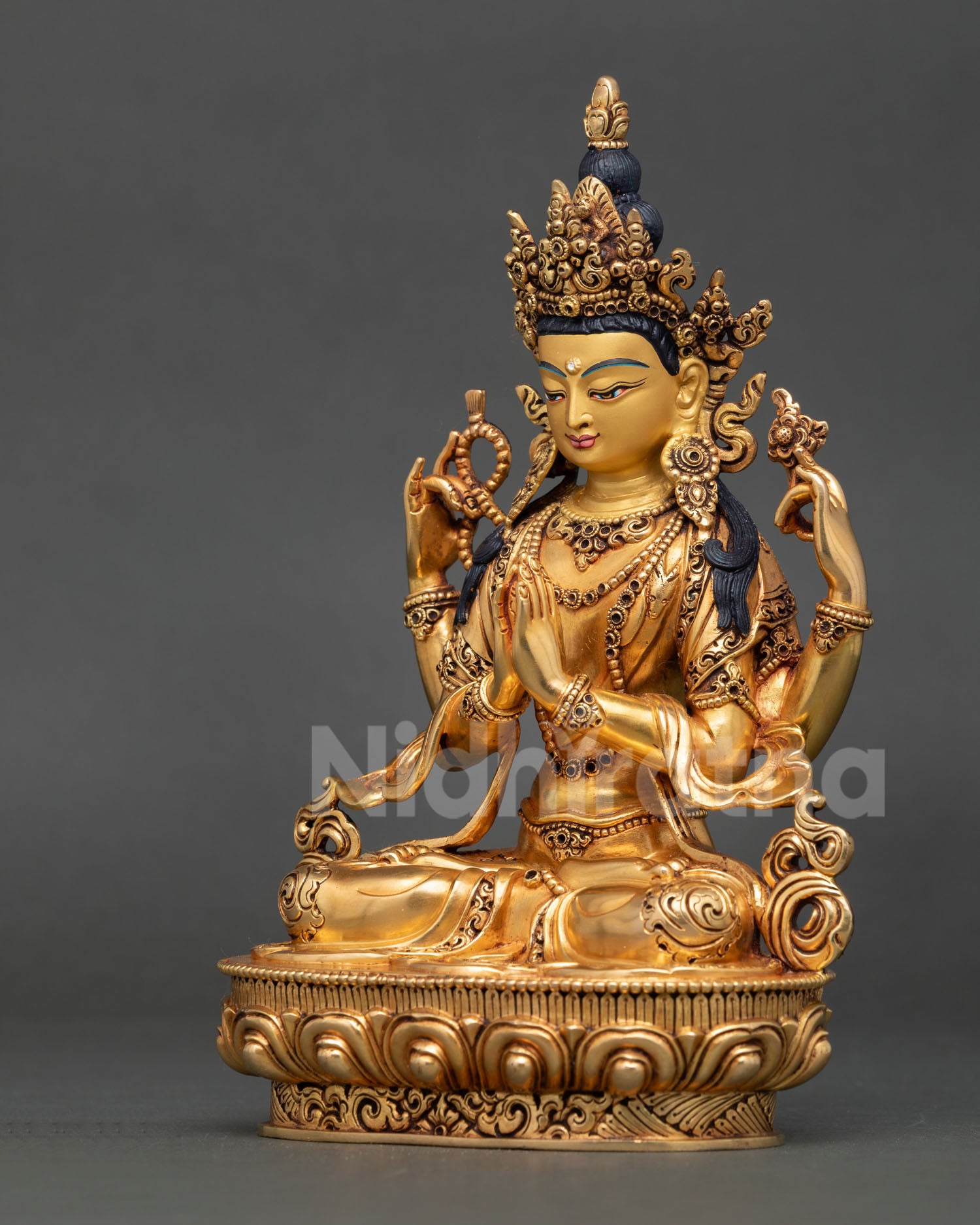 Chenrezig statue left side view, fire-gilded Avalokiteshvara form, sacred jewelry and flowing robe details