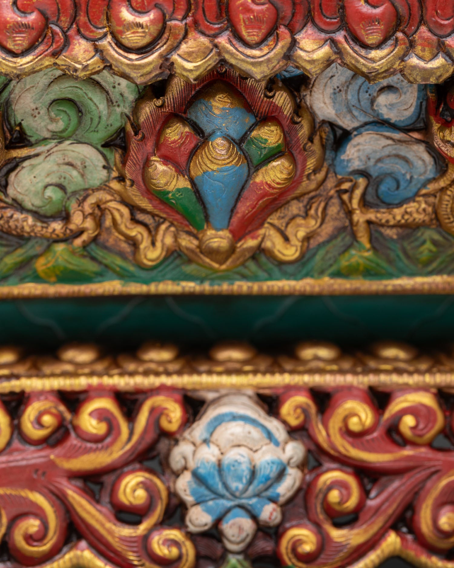 close detail of hand-painted acrylic accents on copper incense holder with gold gilded surface